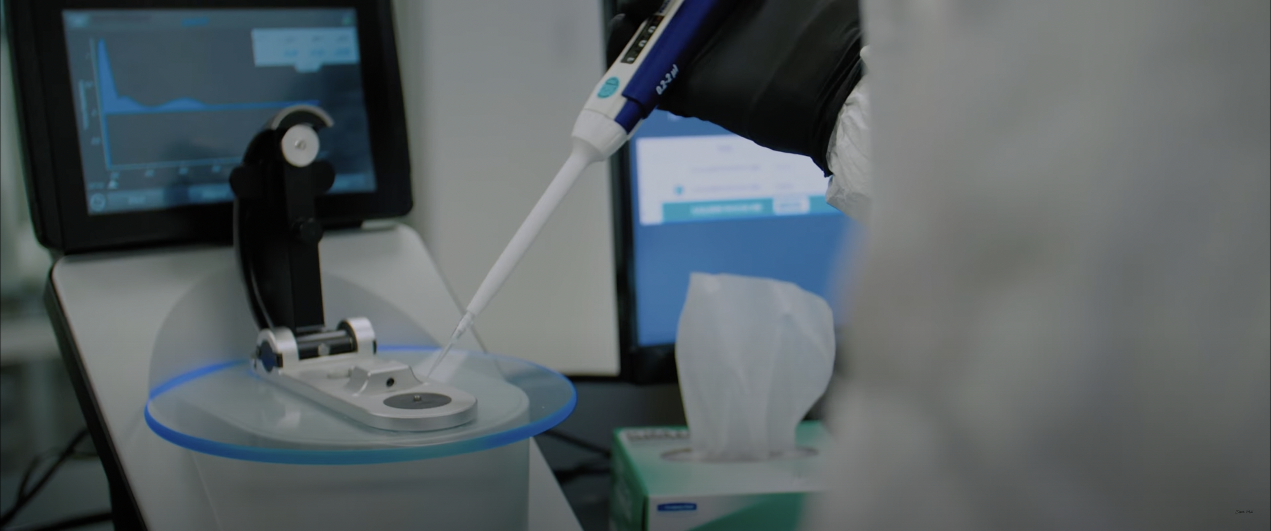 Laboratory equipment with pipette and computer screen