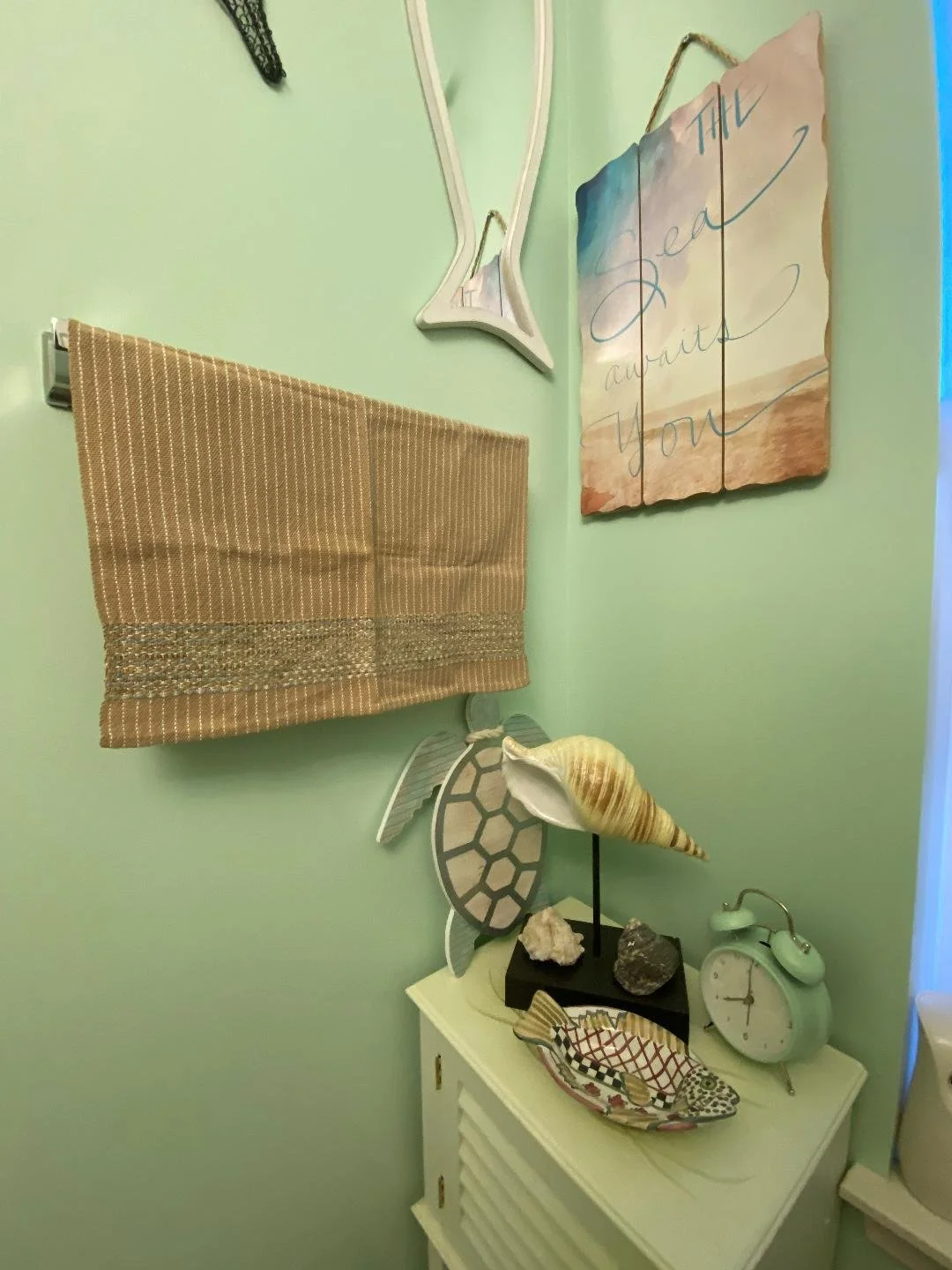 Our luxurious Perfectionist hand towels, featuring hand-painted organic cotton borders, unify the decorative elements in this River Vale, NJ powder room.