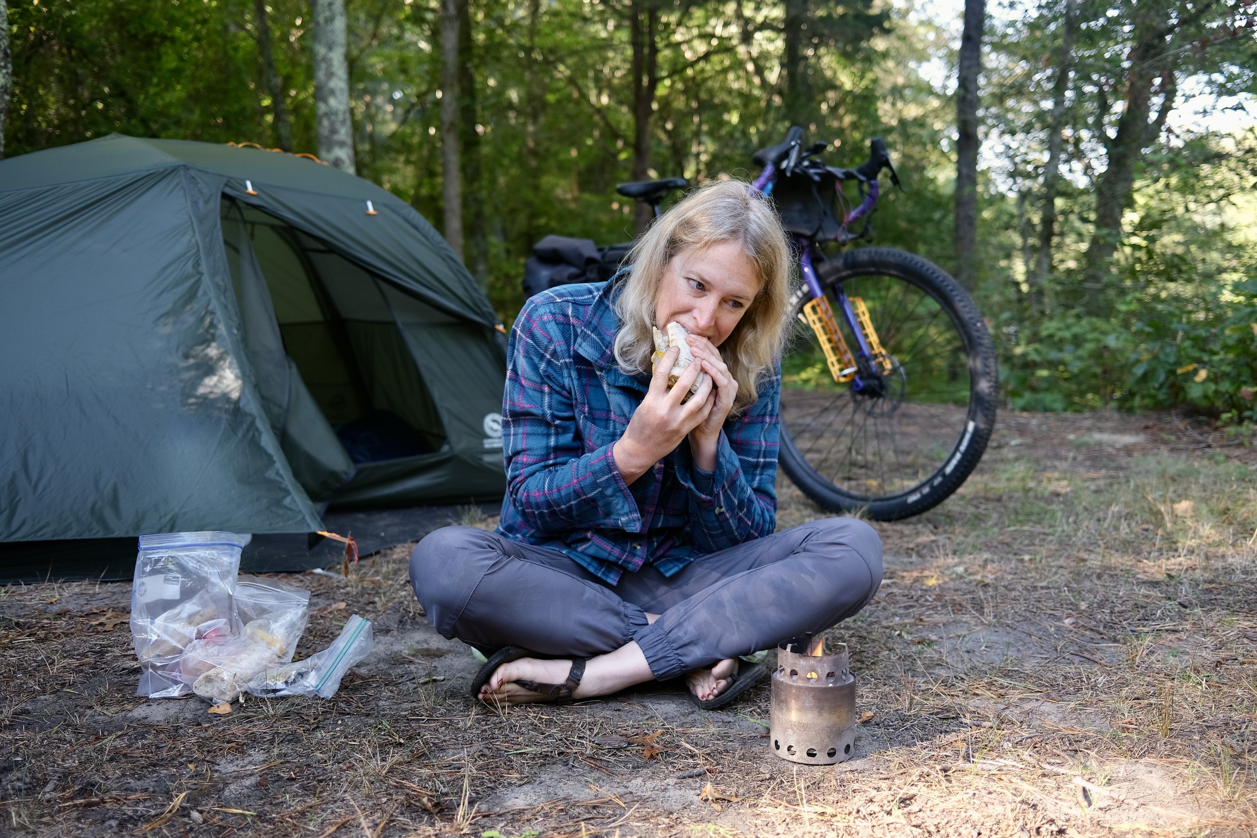 Laura Killingbeck eats a sandwich at camp.