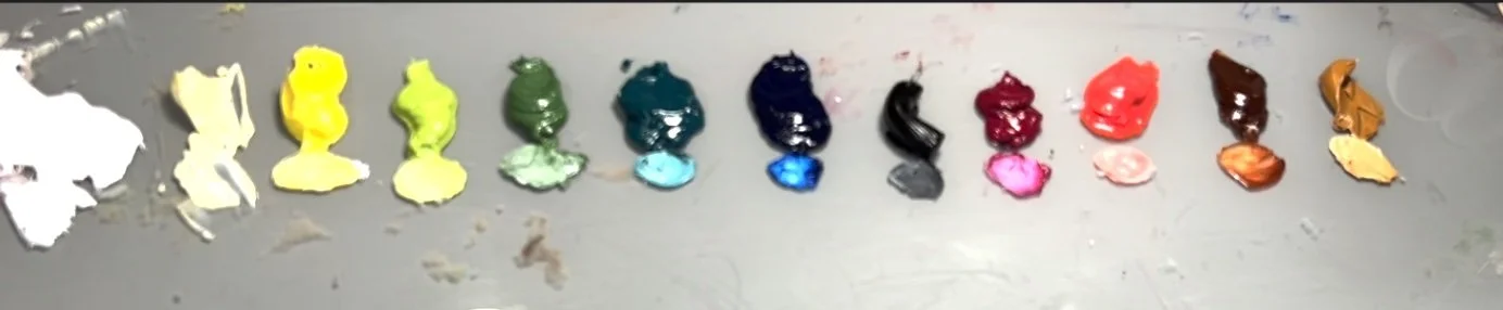 Array of mixed paint blobs in various colors including white, yellow, green, blue, black, pink, red, brown, and orange.