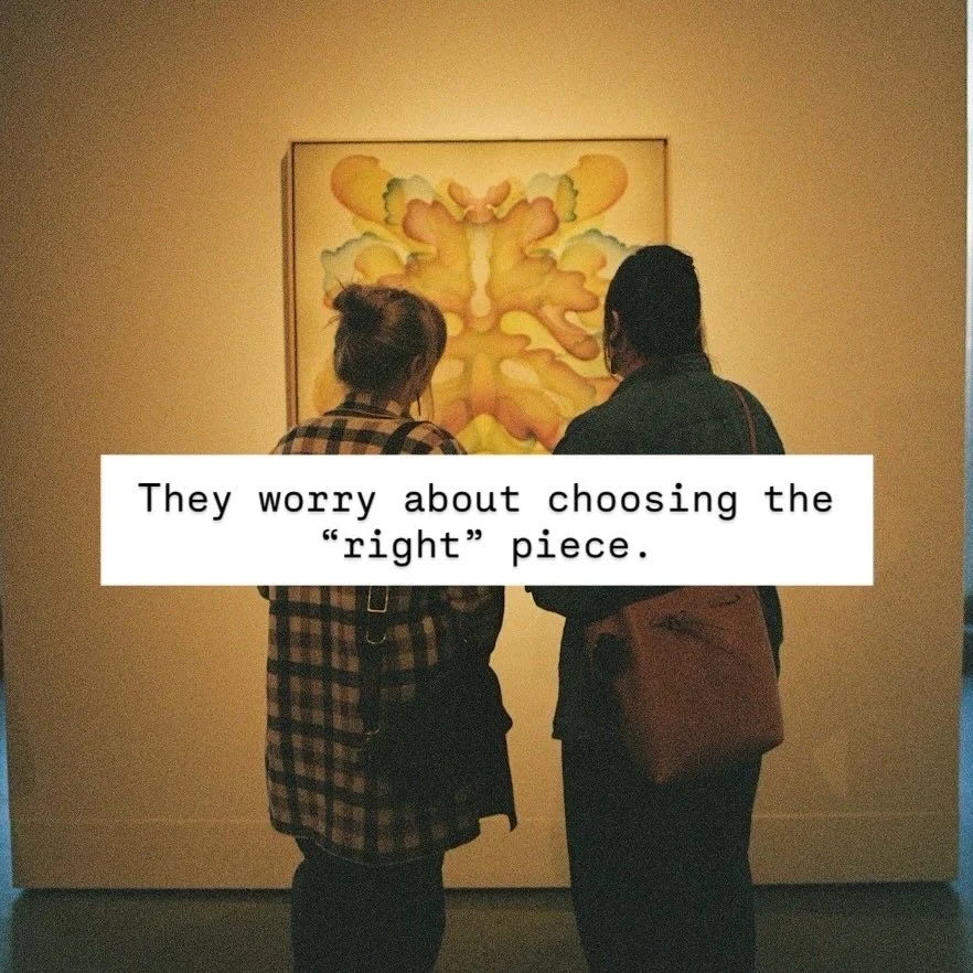 Two people stand in front of an abstract colorful painting at an art gallery, looking at it and discussing.