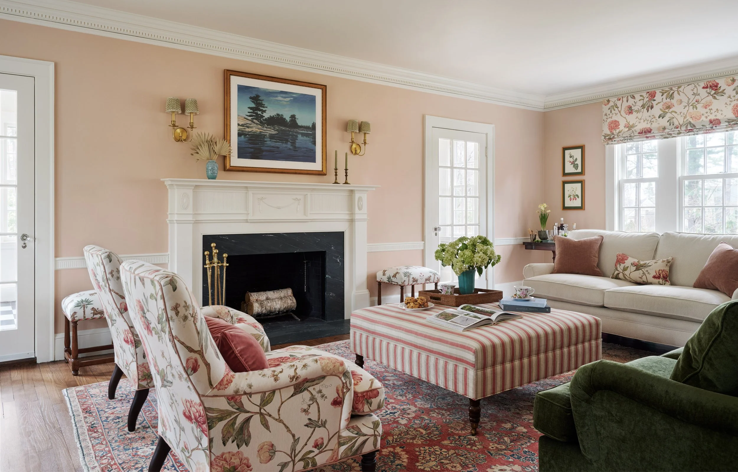 pink living room with layered floral and striped fabrics