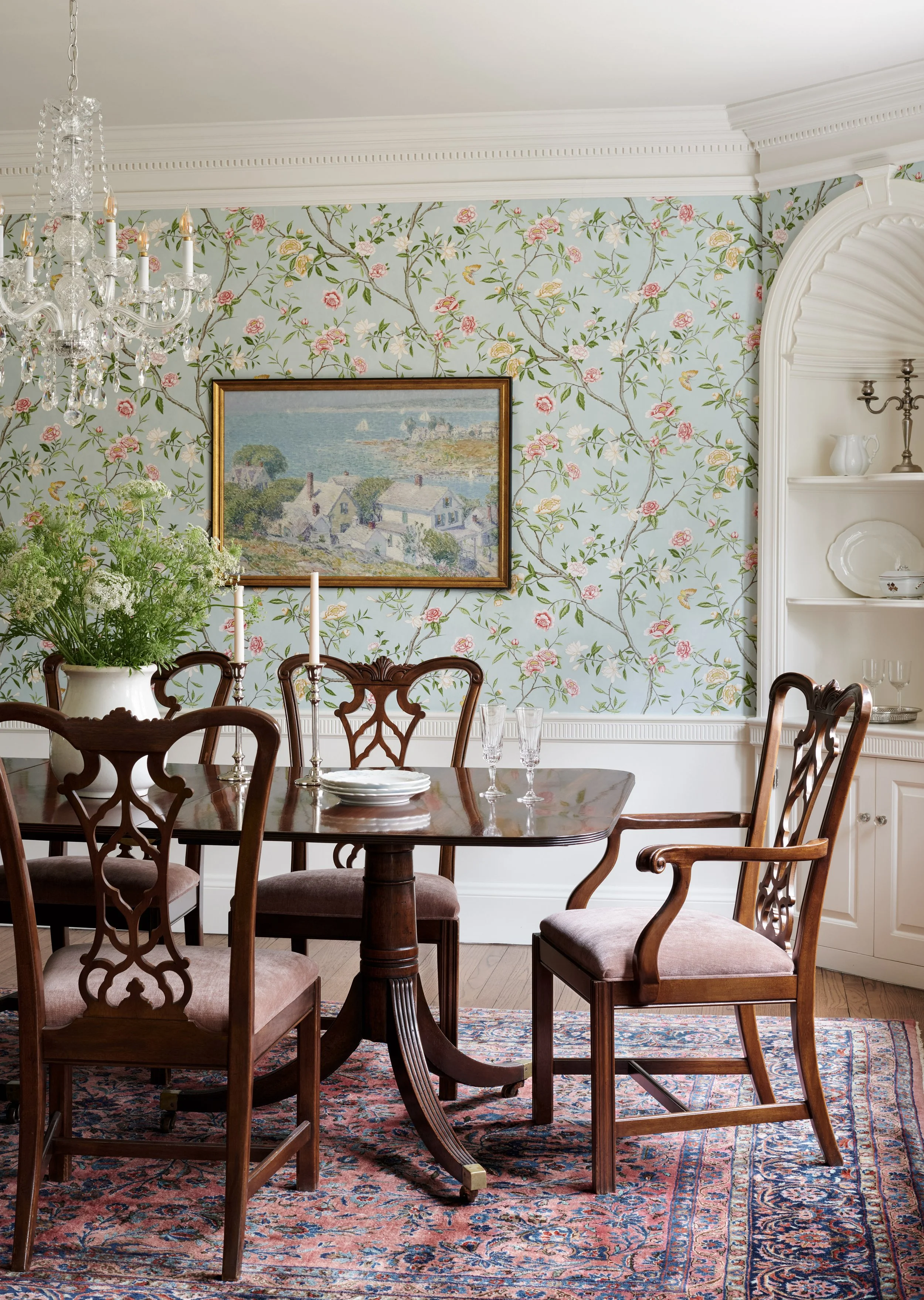 blue dining room with floral wallpaper and vintage furniture