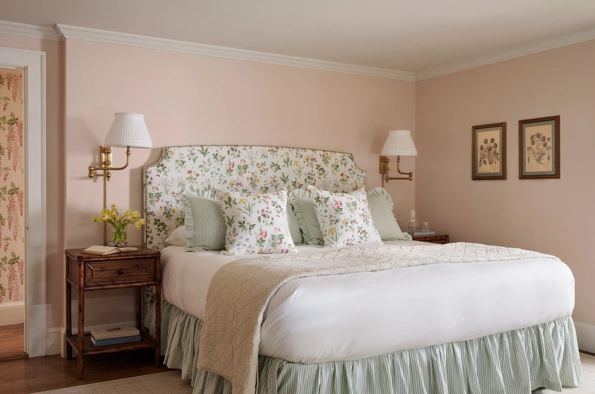 primary bedroom with schumacher floral headboard pink walls