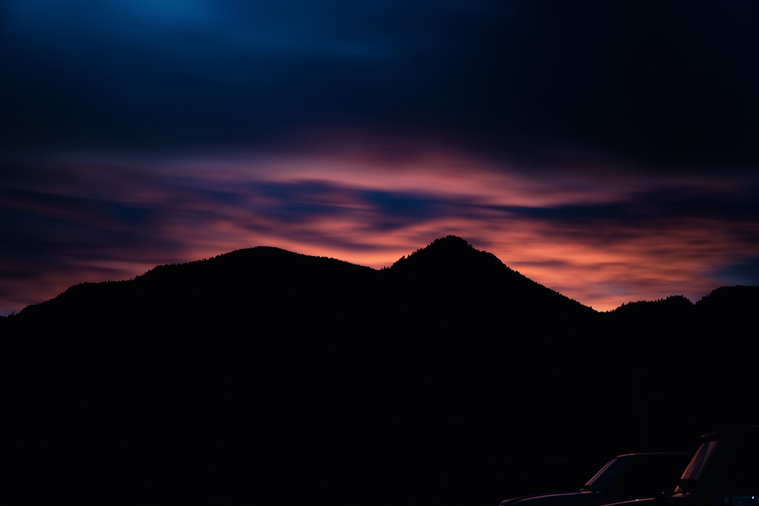 Silhouette of mountains under a colorful sunset sky
