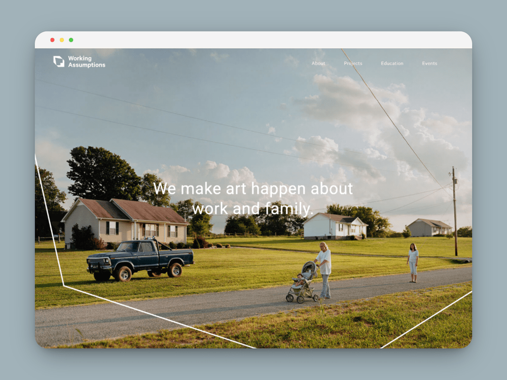Screenshot of a website homepage for Working Assumptions featuring a rural scene with a man pushing a stroller and a woman walking, with houses, a truck, and trees in the background.