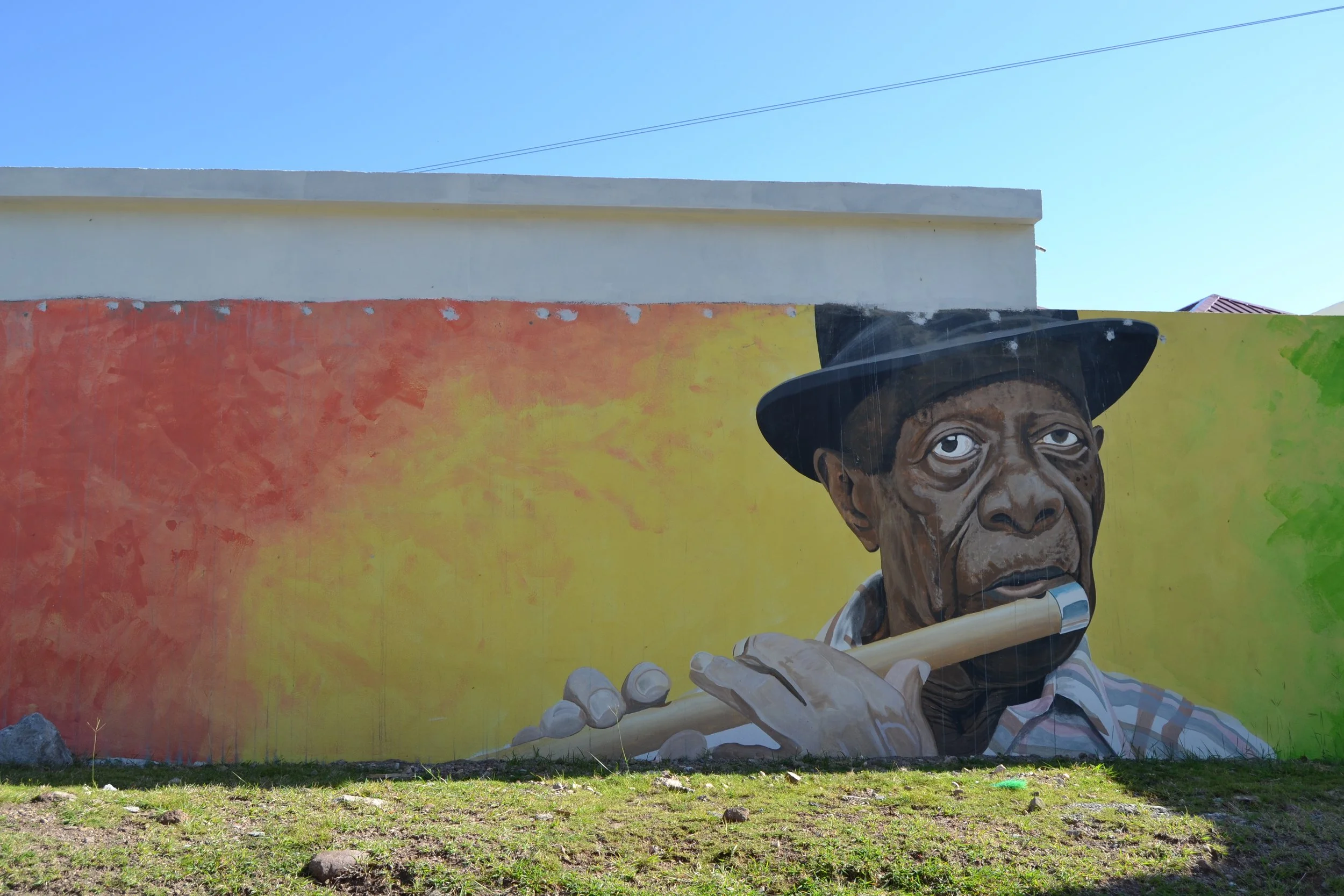  A mural of David Freeman, nicknamed ‘De Maestro’. He is a musical icon on Nevis, known as a Patron for Culturama and bandmate in many stringbands. His legacy now lives on through an arts, music, and culture center in Gingerland.    