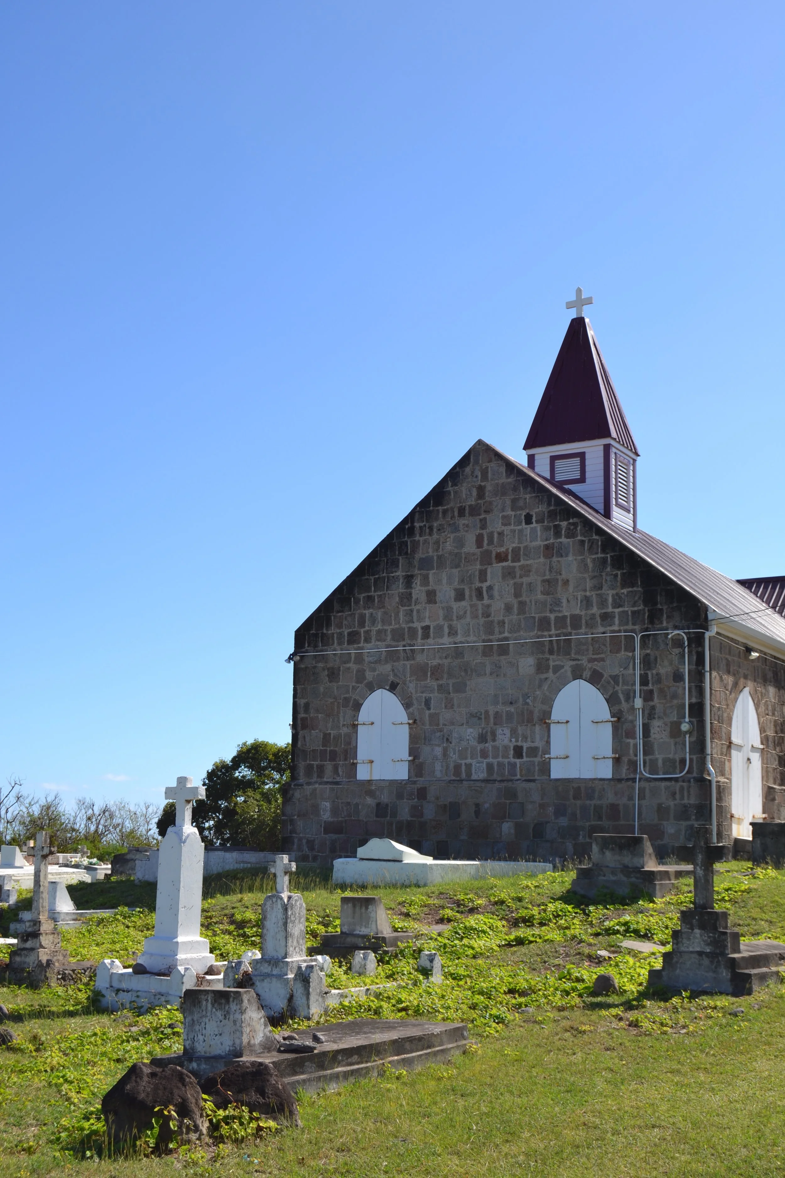  A view of St. James Windward Church in the north part of Nevis. The church was built in the late 17th century and is one of three Anglican Churches in the Caribbean to display a Black crucifix. 