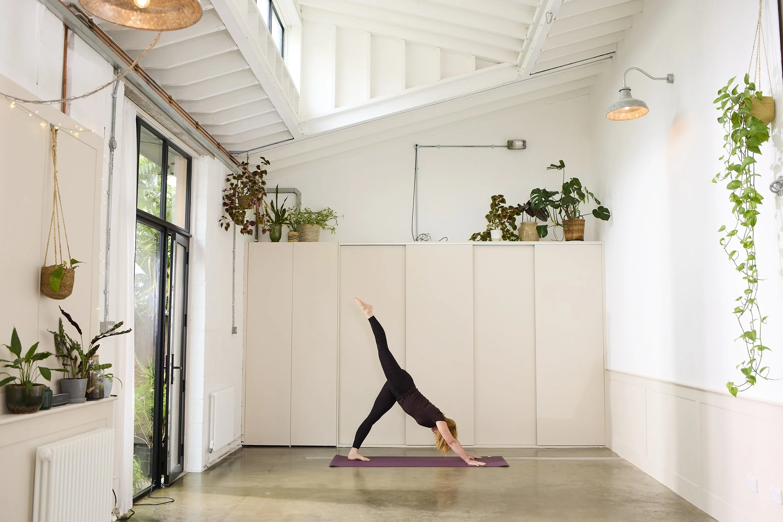 group yoga class at Kingston London doing shoulder stand
