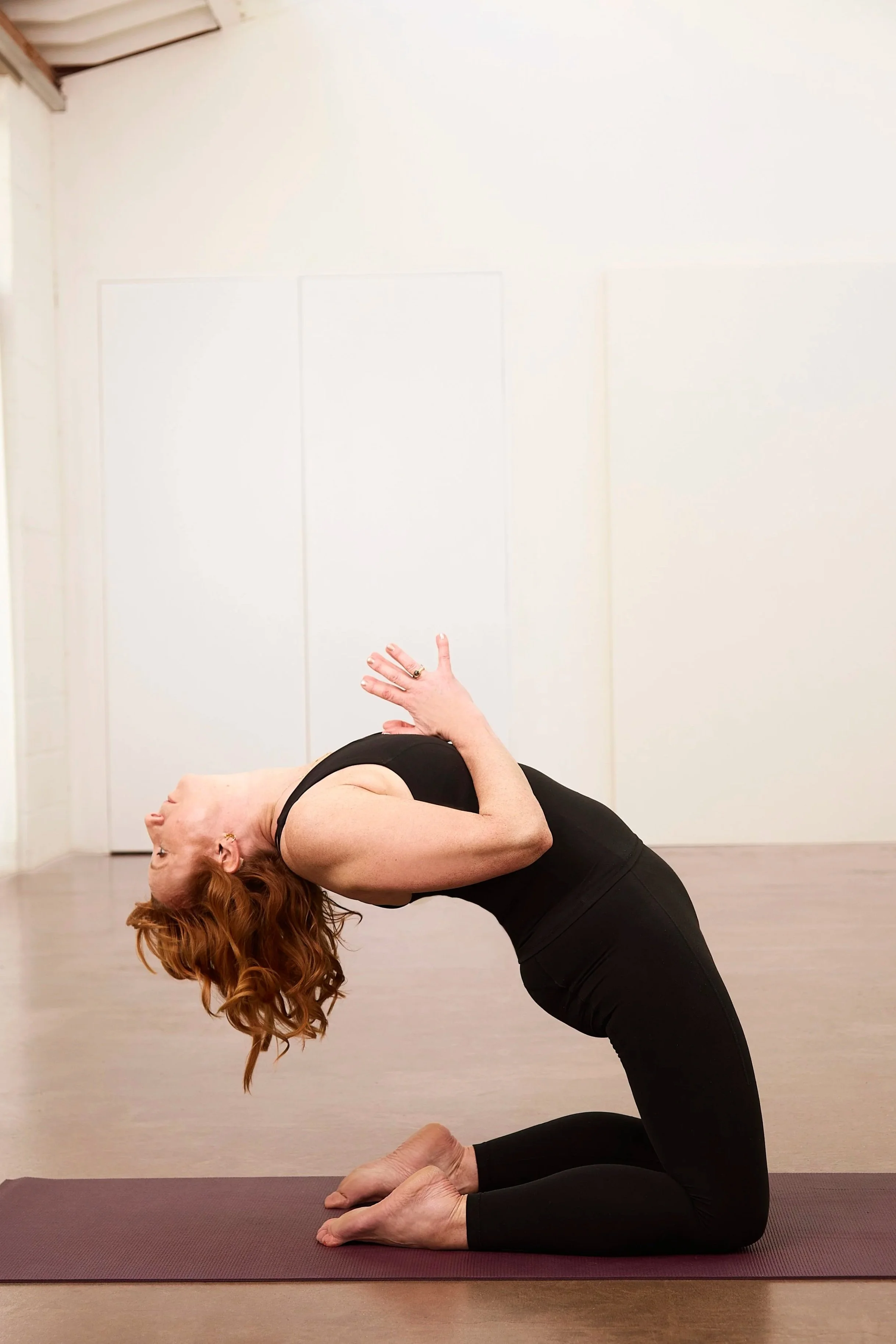 back bending pose surrounded by plants