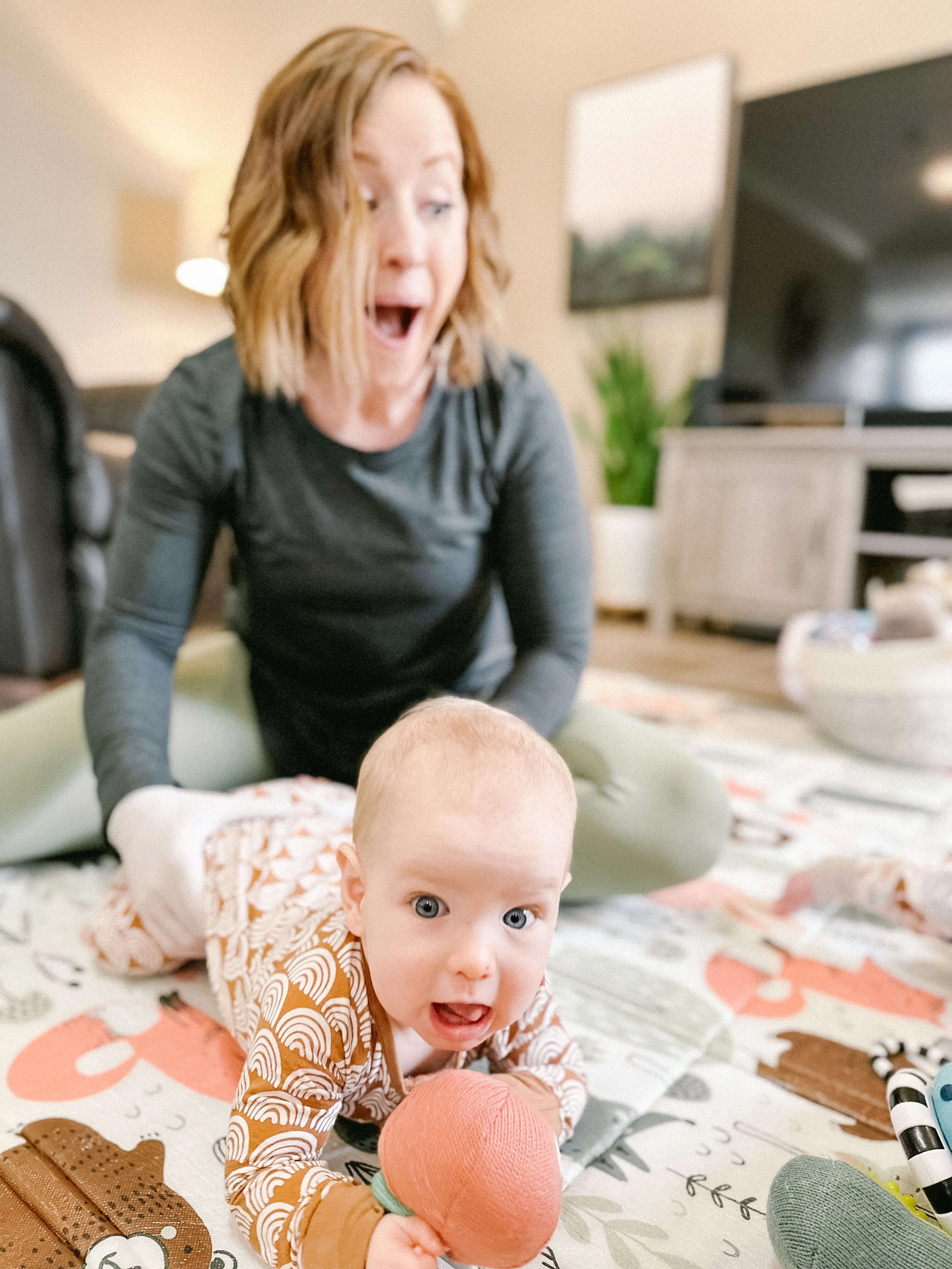 A female doing bodywork with an infant in tummy time