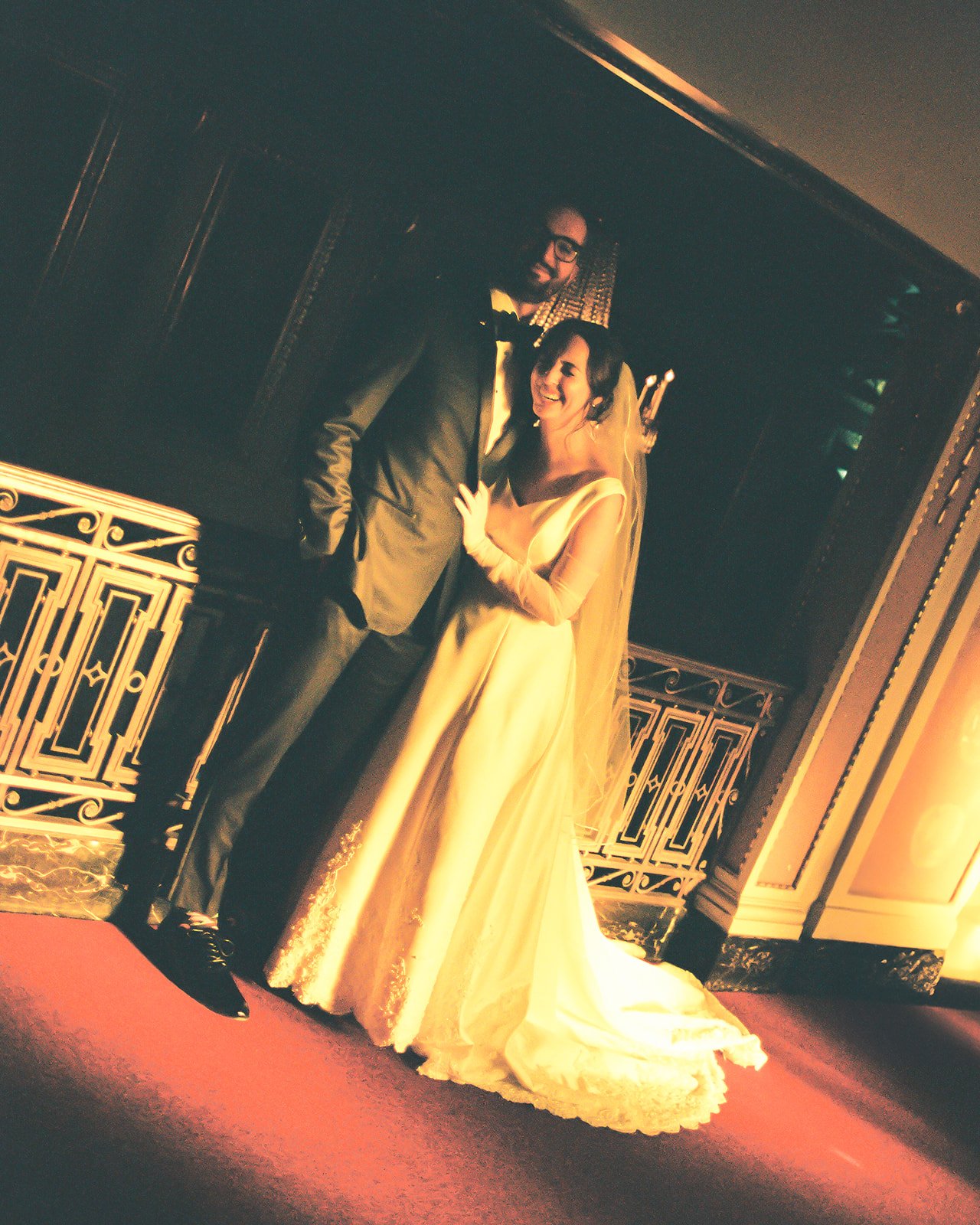 A bride and groom candidly laughing on their wedding day, New York City
