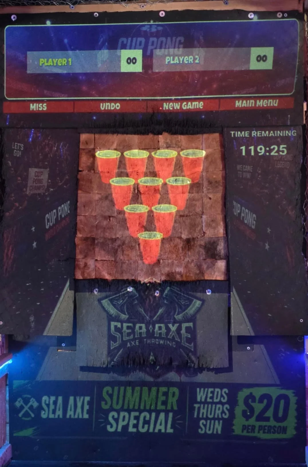 Cup Pong axe throwing game displayed on a projected target at Sea Axe Axe Throwing.