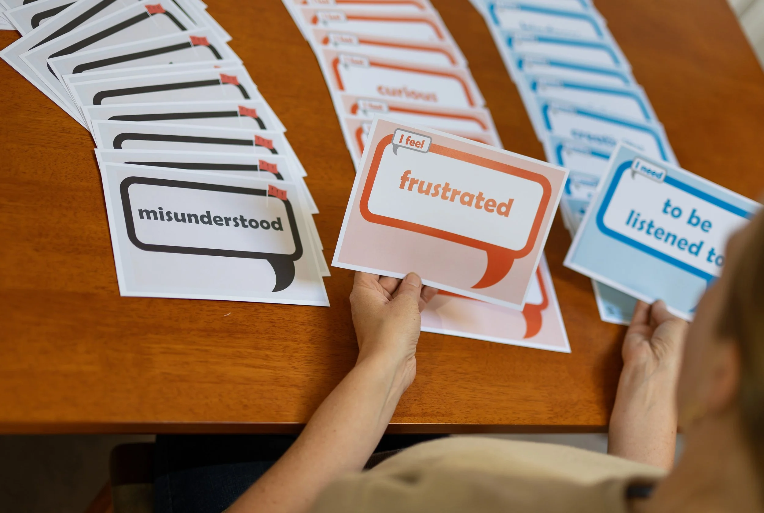 Person using feelings and needs cards.