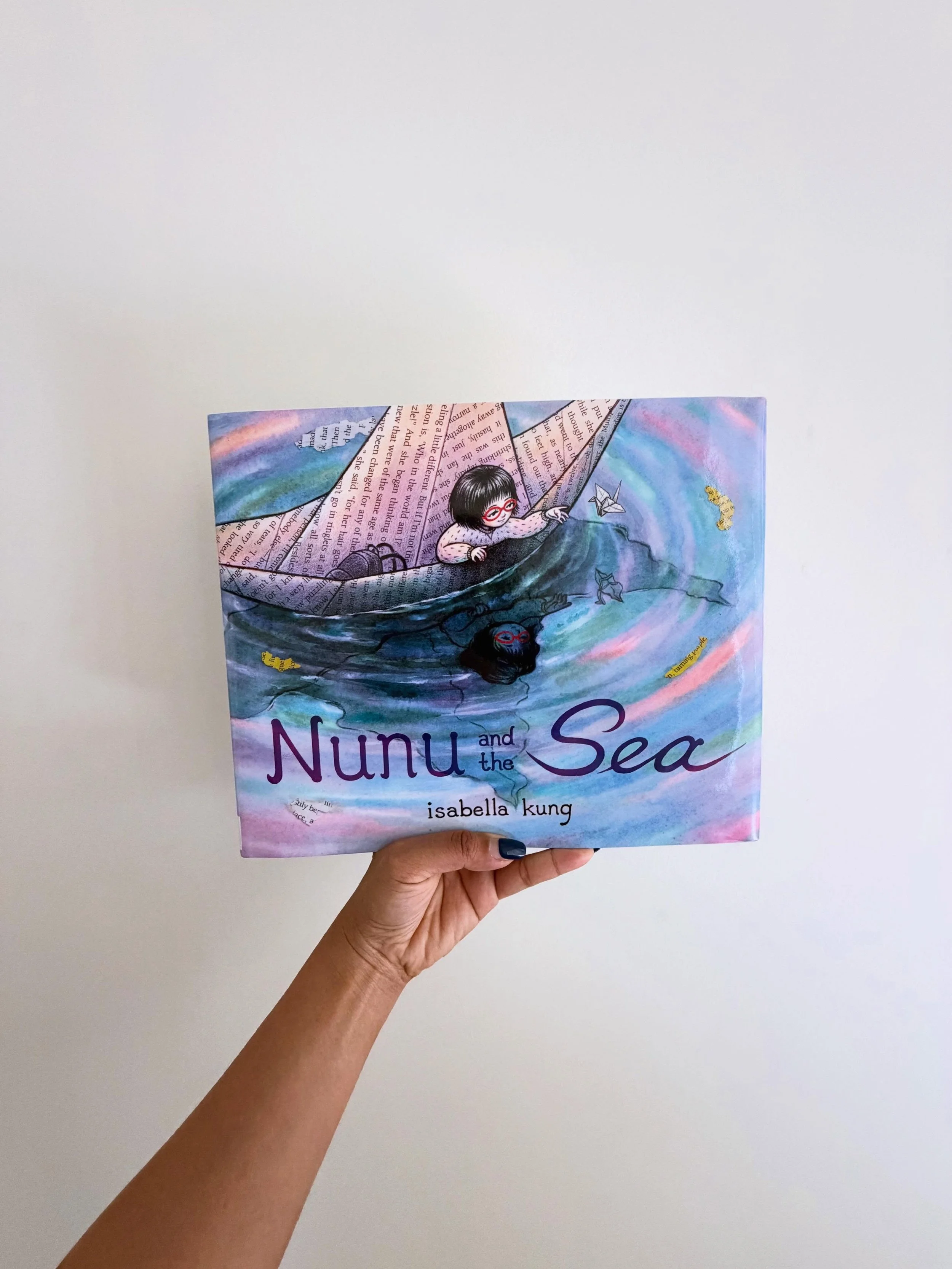 Nunu is overwhelmed. She slams her door, screams, and tears up the origami house on her desk. Her tears become an ocean, and she sails away in a paper boat. Out at sea, she folds more origami creatures to keep her company. The yellow scraps of her de