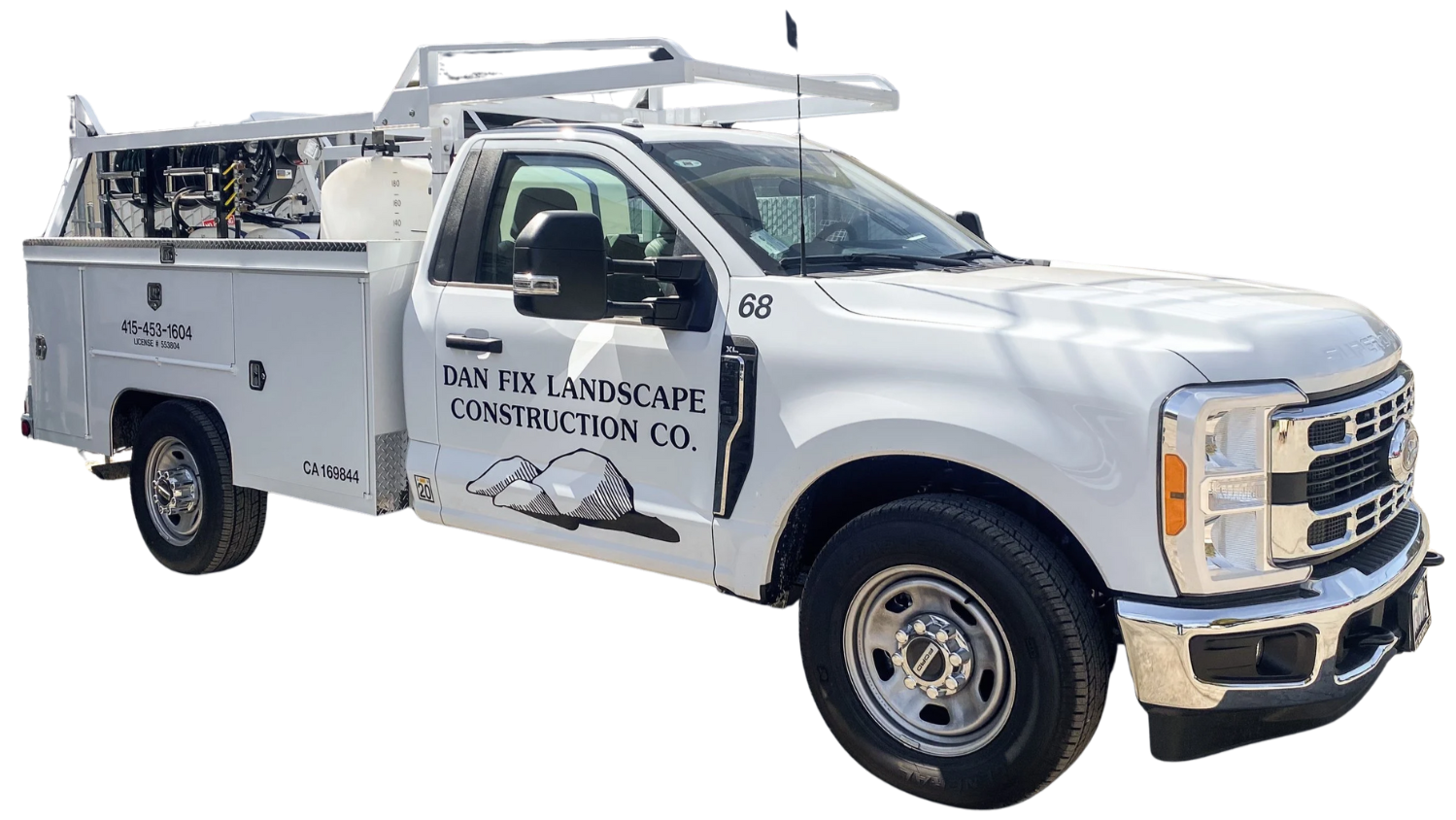 White work truck with the branding "Dan Fix Landscape Construction Co." on the side, equipped with tools and equipment for landscaping or construction work