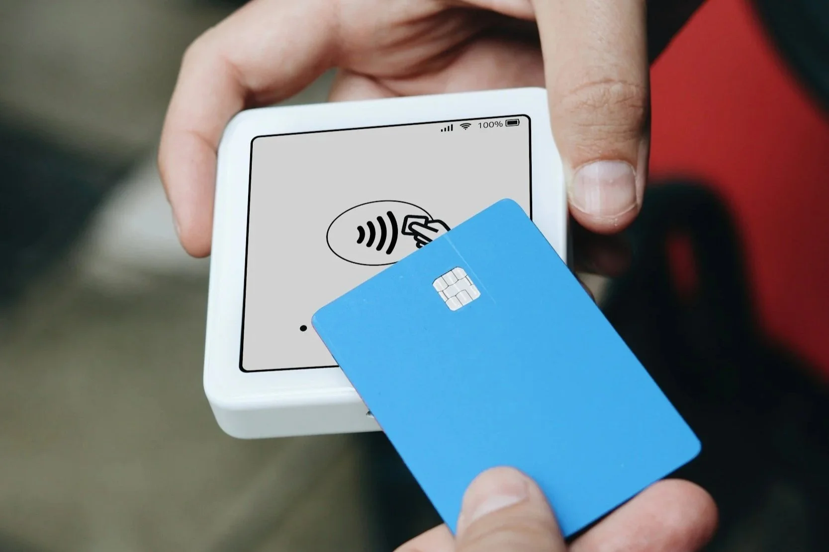 Credit card being used on a handheld payment processor