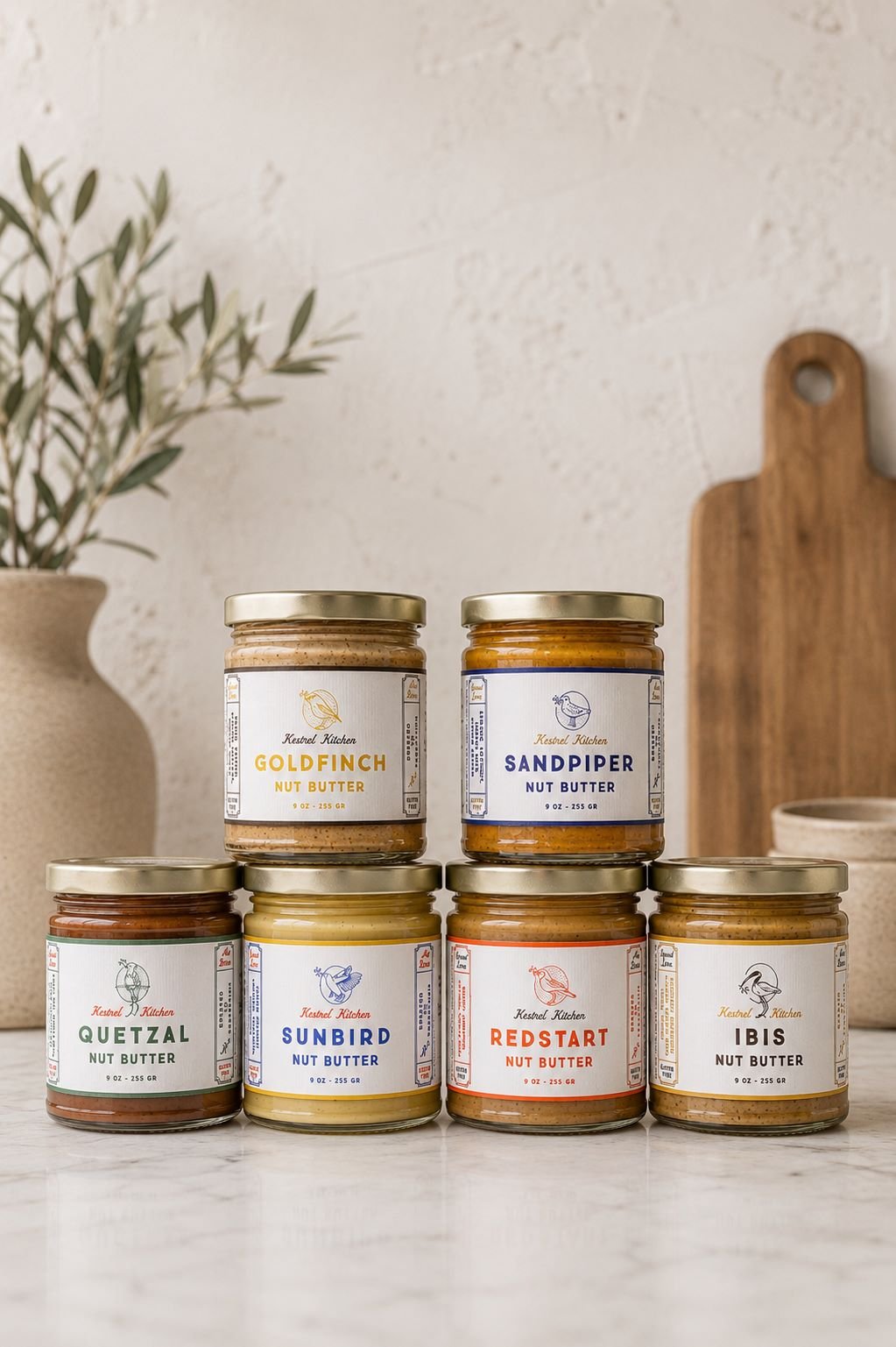 photo of six different gourmet nut butters stacked in luxury kitchen