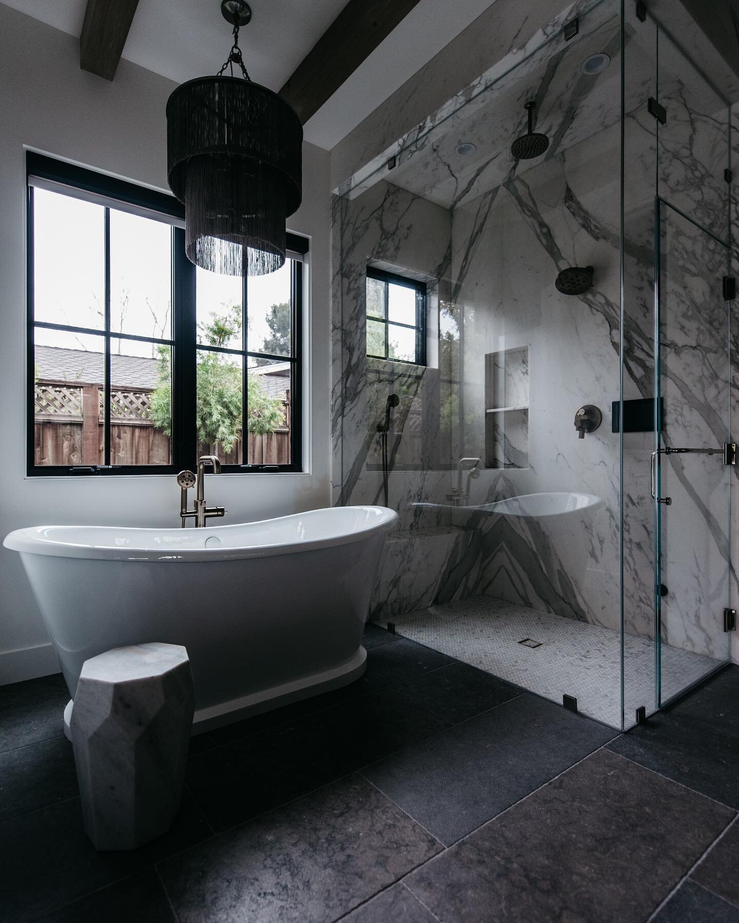 Newly completed master bath. This @signaturehw cast iron skirted tub and @arteriorshome James chandelier add the perfect touch of glam to this modern design. Another dream home complete 👌🏻. #signaturehardware #arteriorslighting #urbanpachomes #briz