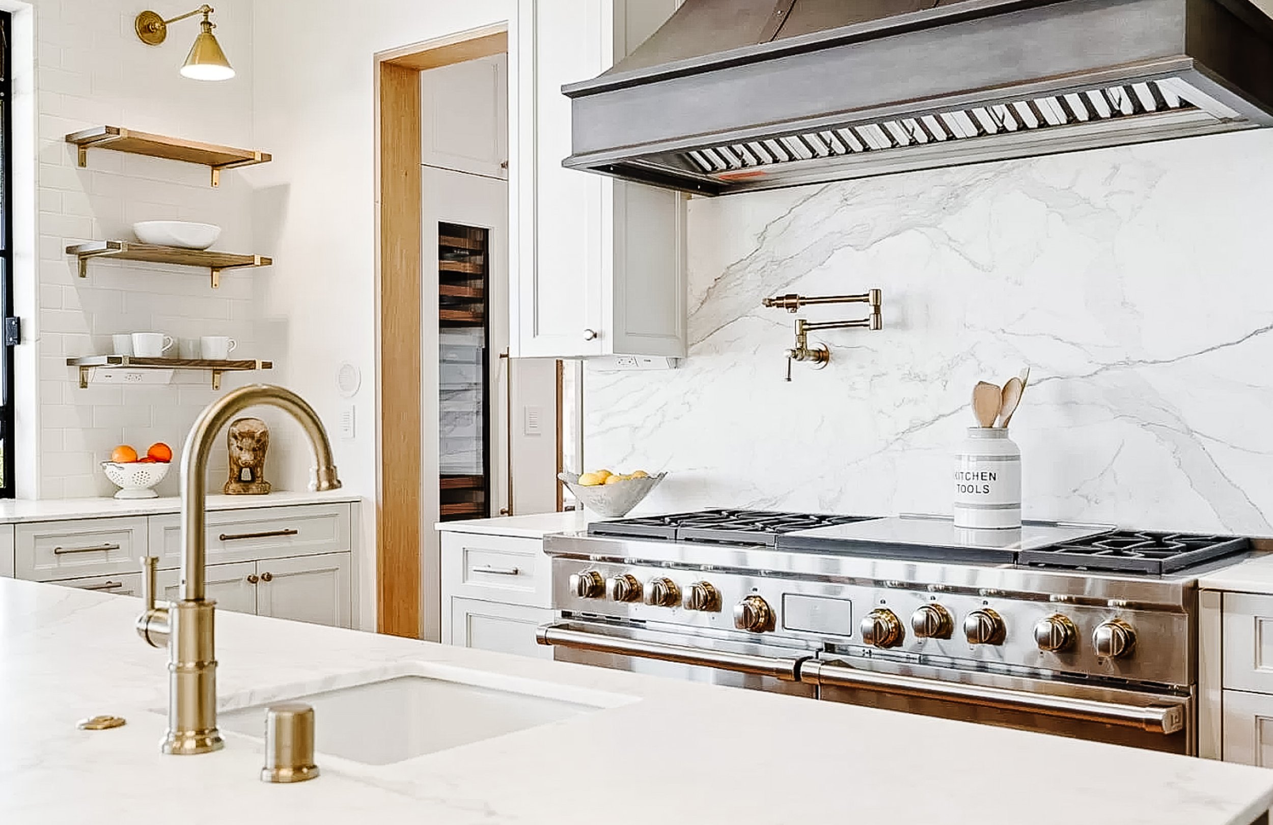 Appliances include: Wolf gas range with 6 burners, double griddle, 2 full ovens, and pot filler; Wolf microwave, steam oven, and warming drawer; 2 Bosch dishwashers; Sub-Zero refrigerator and freezer, each with two drawers