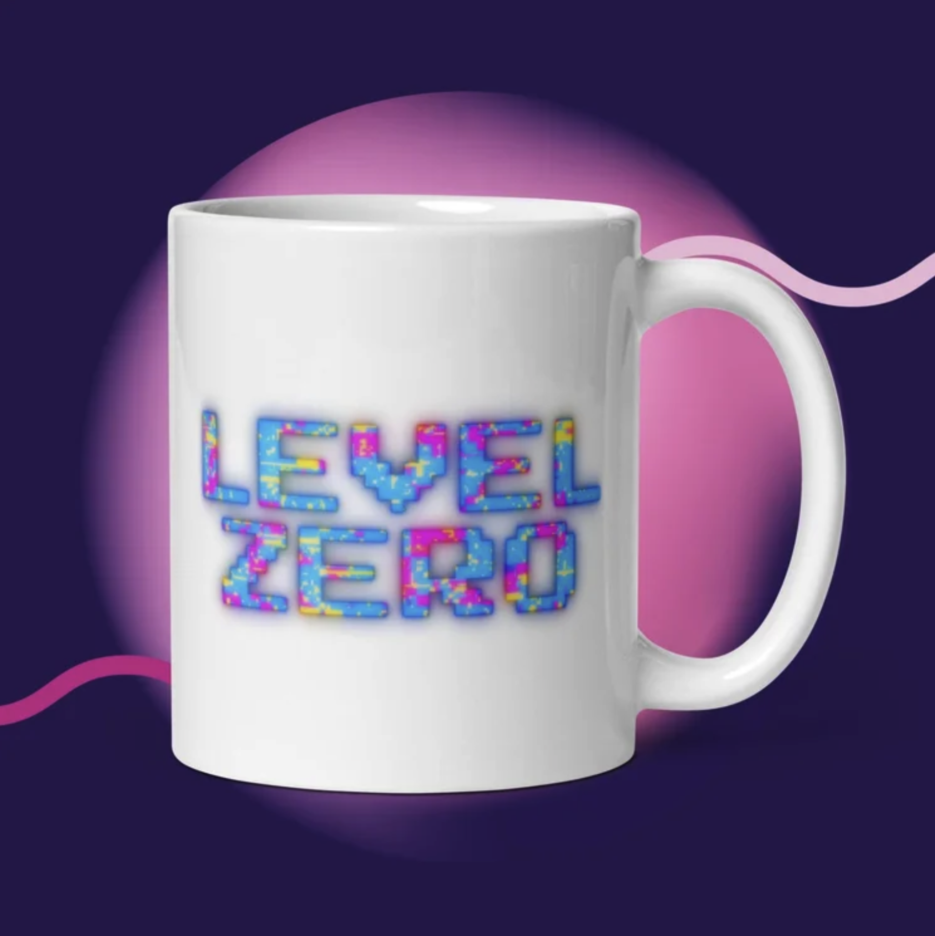 Close-up of a white coffee mug with colorful letters spelling 'FEEL FREE' on a dark purple background with pink and purple abstract shapes.