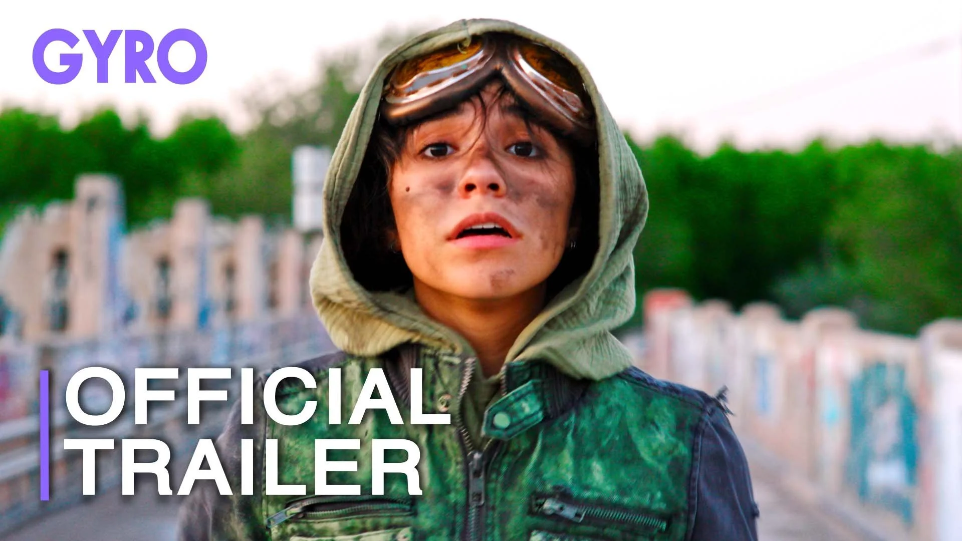 A man with a beard and long hair wearing a hooded sweatshirt, looking surprised or alarmed, with text indicating it's an official trailer for a film called "Gyro."