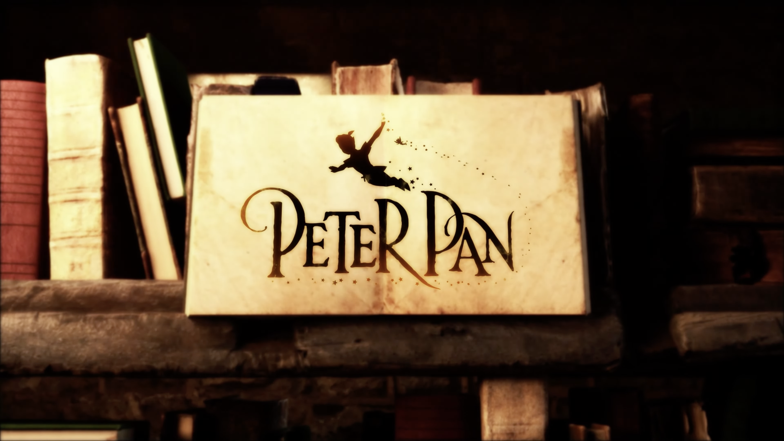 A book with the title 'Peter Pan' featuring a silhouette of Peter Pan flying and sprinkling pixie dust.