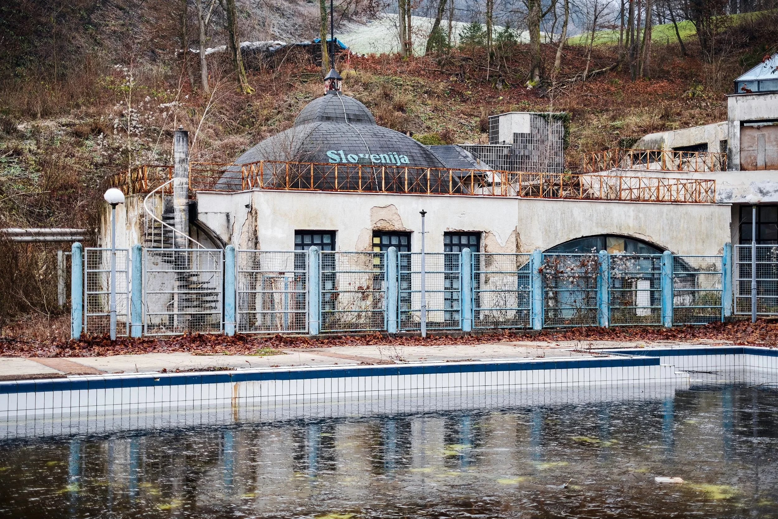 An empty pool reflecting a domed pavilion in winter light