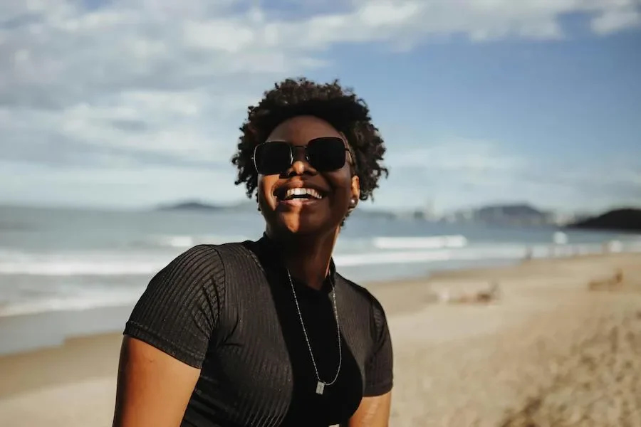 a woman smiling at the beach