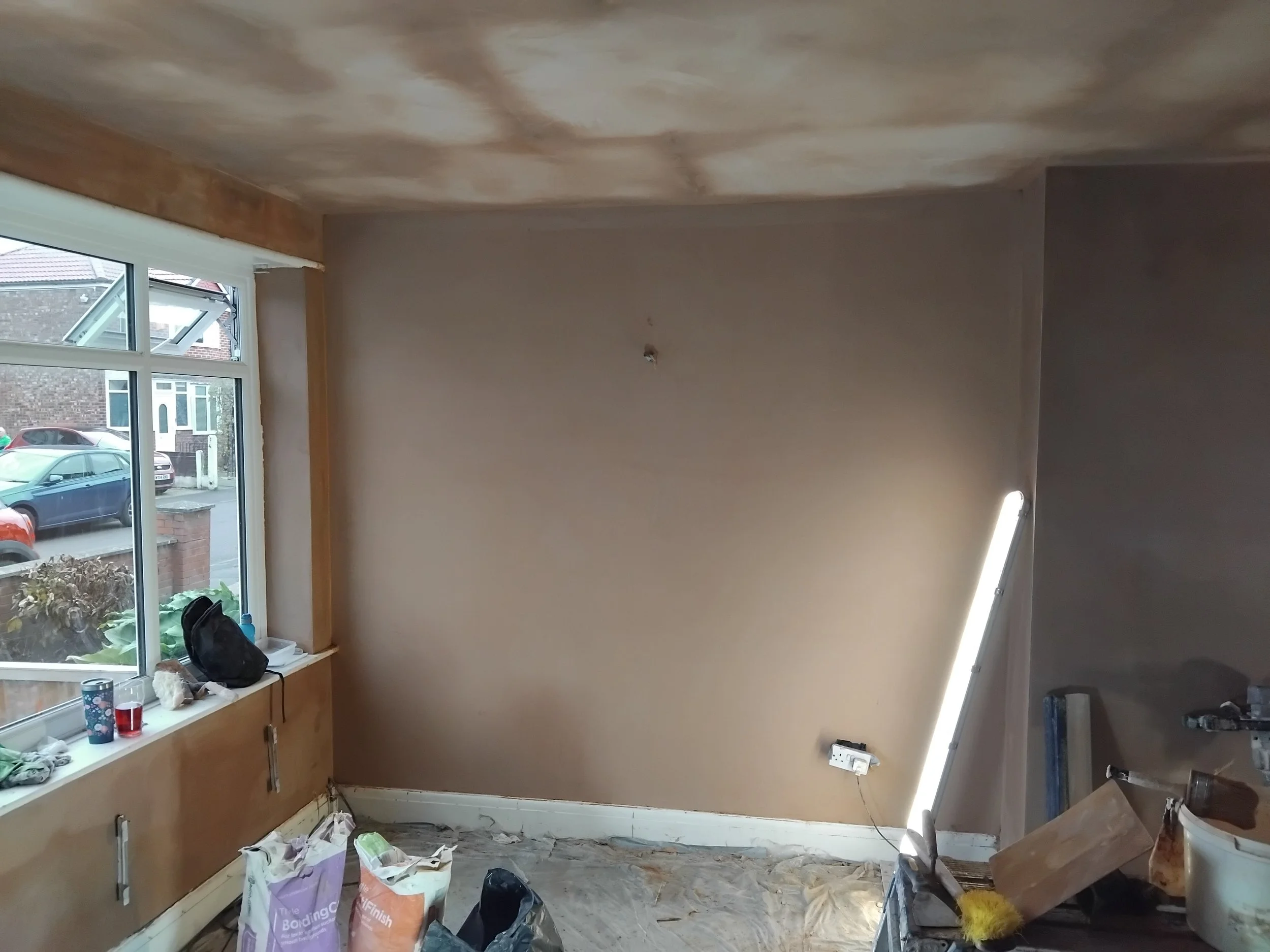 Living room walls skimmed in Tameside 
