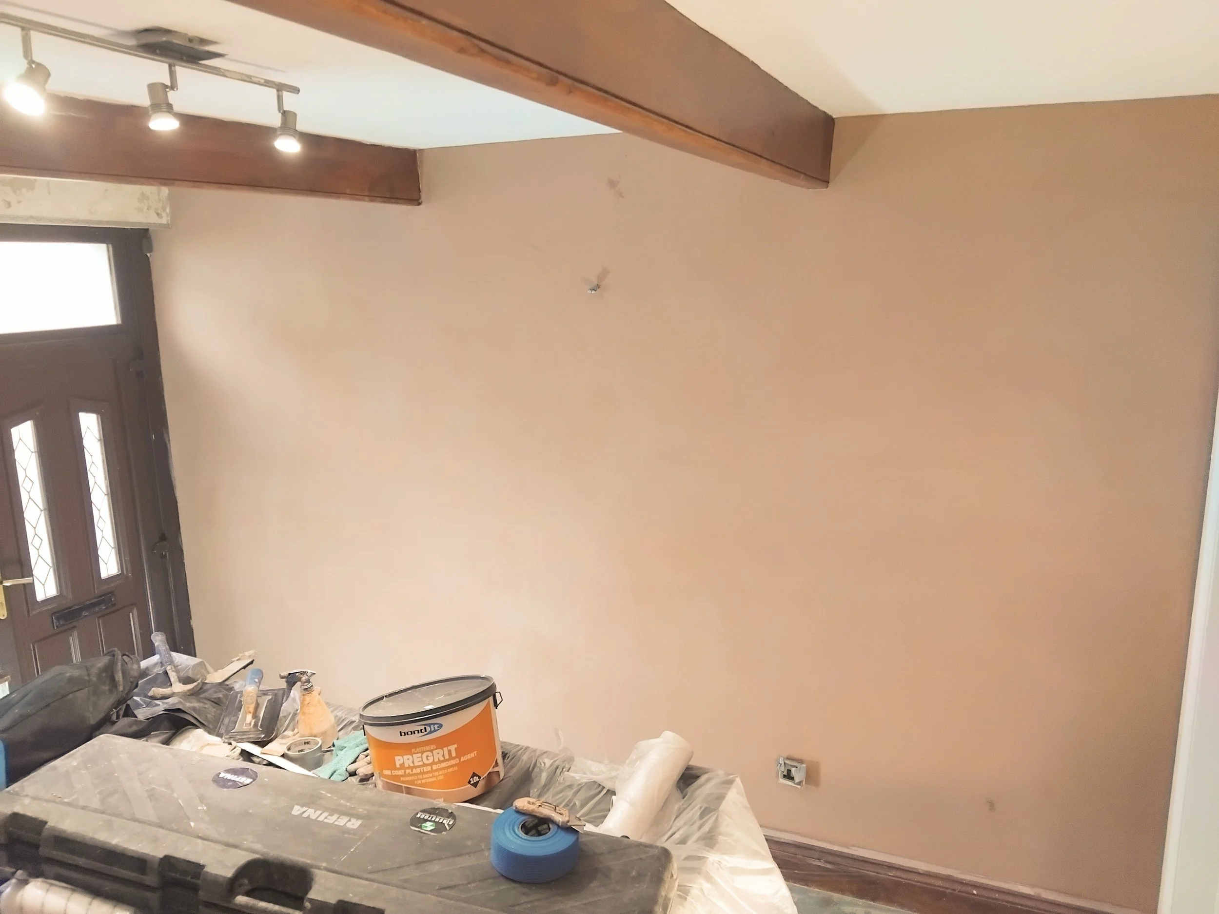 Living room wall plastered in High Peak 