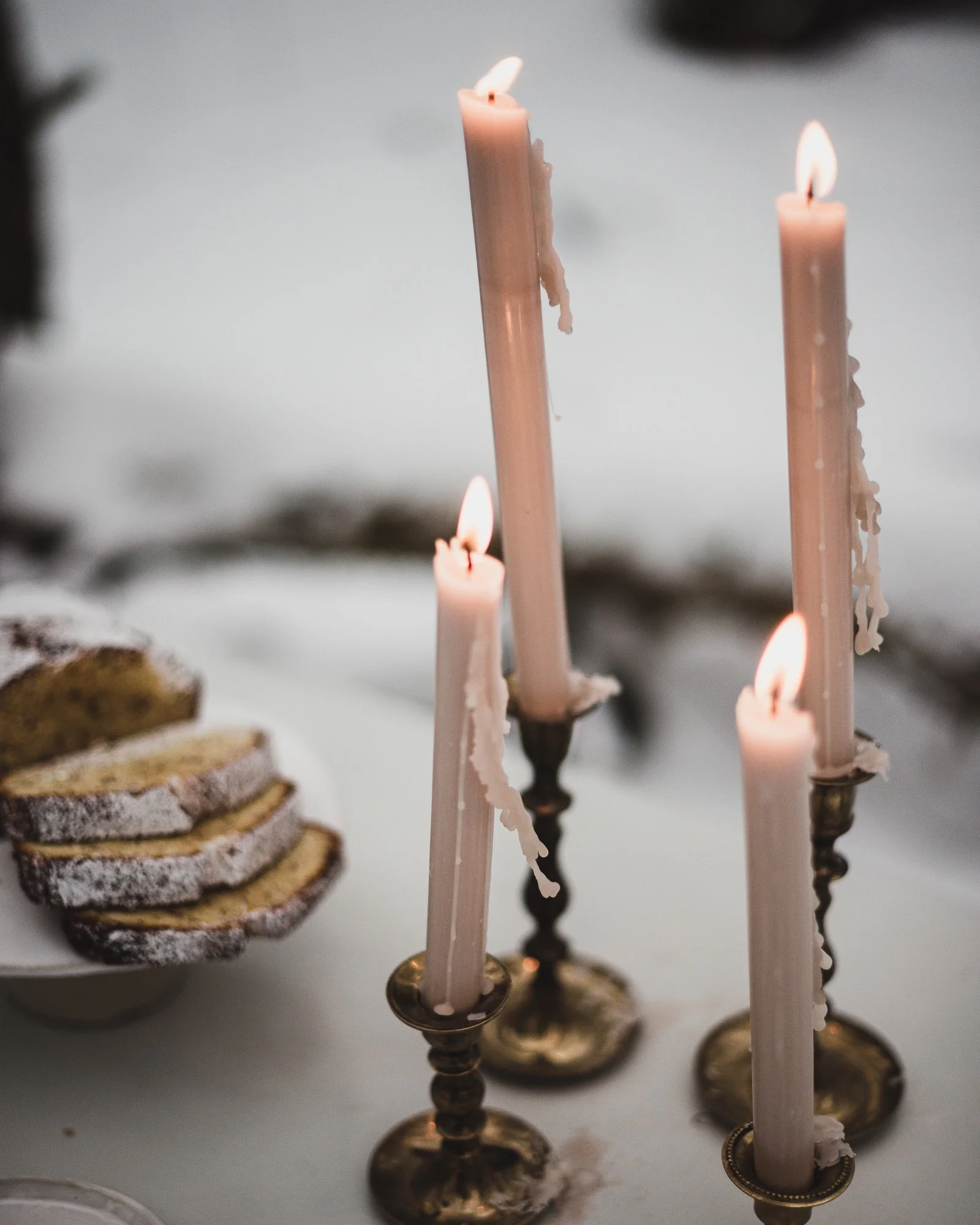 Close-up of warm candlelight in snow, evoking cozy mood.