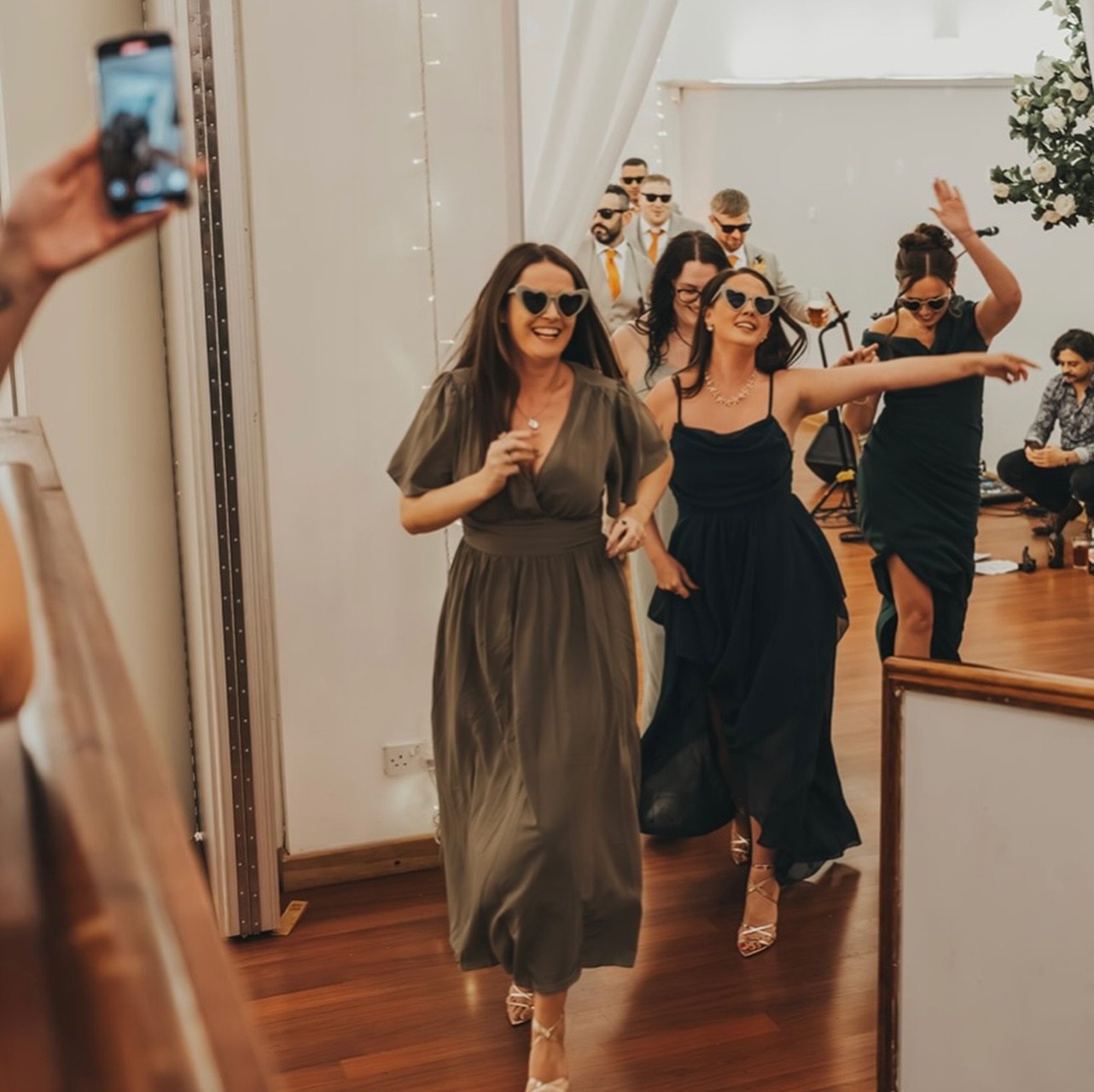 You don&rsquo;t just press play 🎶

Turning a song on
does NOT create this.

You need:

1️⃣ Someone holding the bridal party back
2️⃣ Someone setting the room
3️⃣ Someone hyping the people

Glasses ready.
Napkins untied.
Music LOUD.
Everyone inside.
