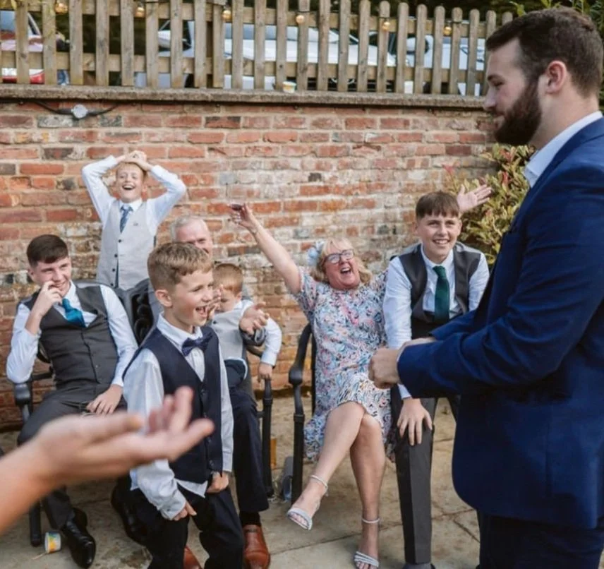 bat mitzvah magician is doing a crazy magic trick for the family