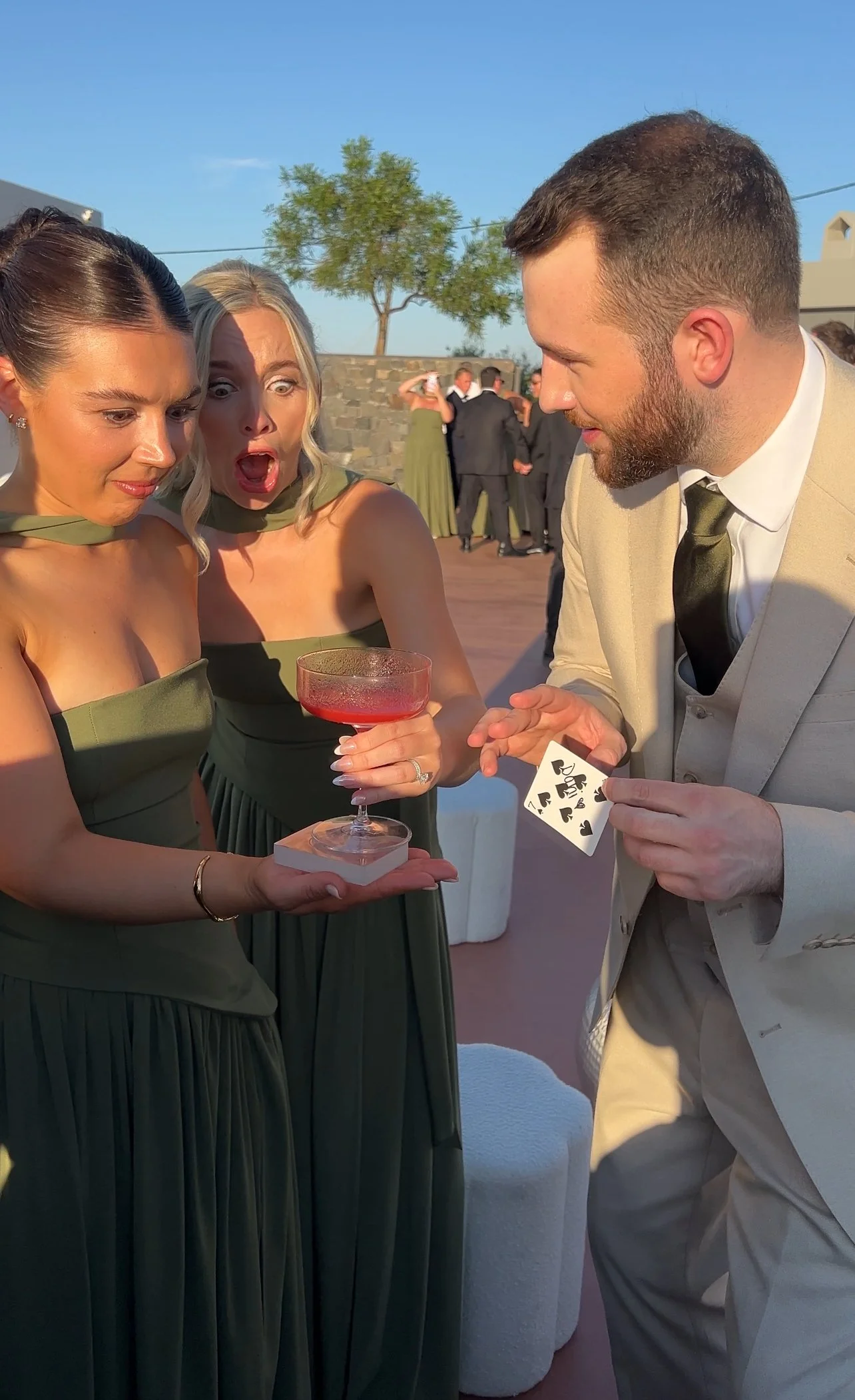 Destination Wedding Magician is entertaining the bridesmaids with magic