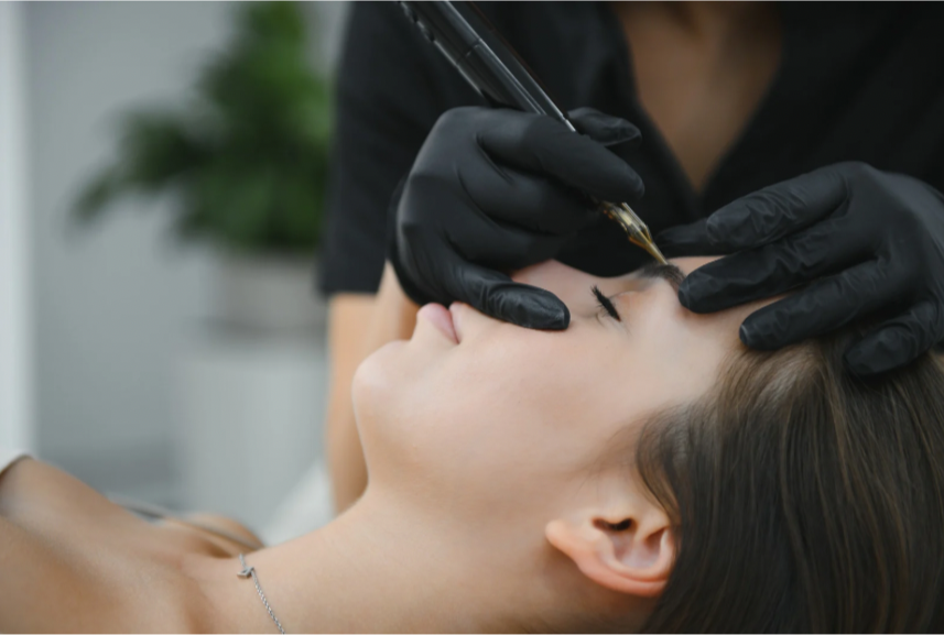 A woman receiving a cosmetic treatment with a syringe by a professional in black gloves.