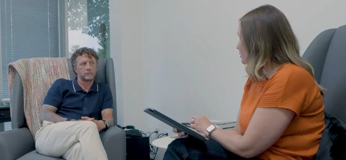 Image of two people talking to one another