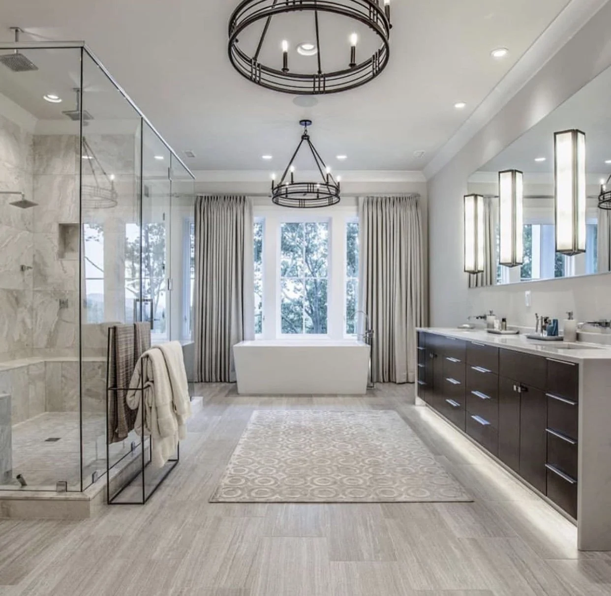 Luxury bathroom remodel with freestanding tub, glass-enclosed shower, custom double vanity, and modern lighting fixtures