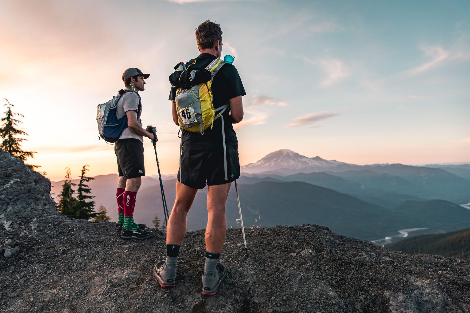  Two runners taking in the view of Mt Rainier at sunset 