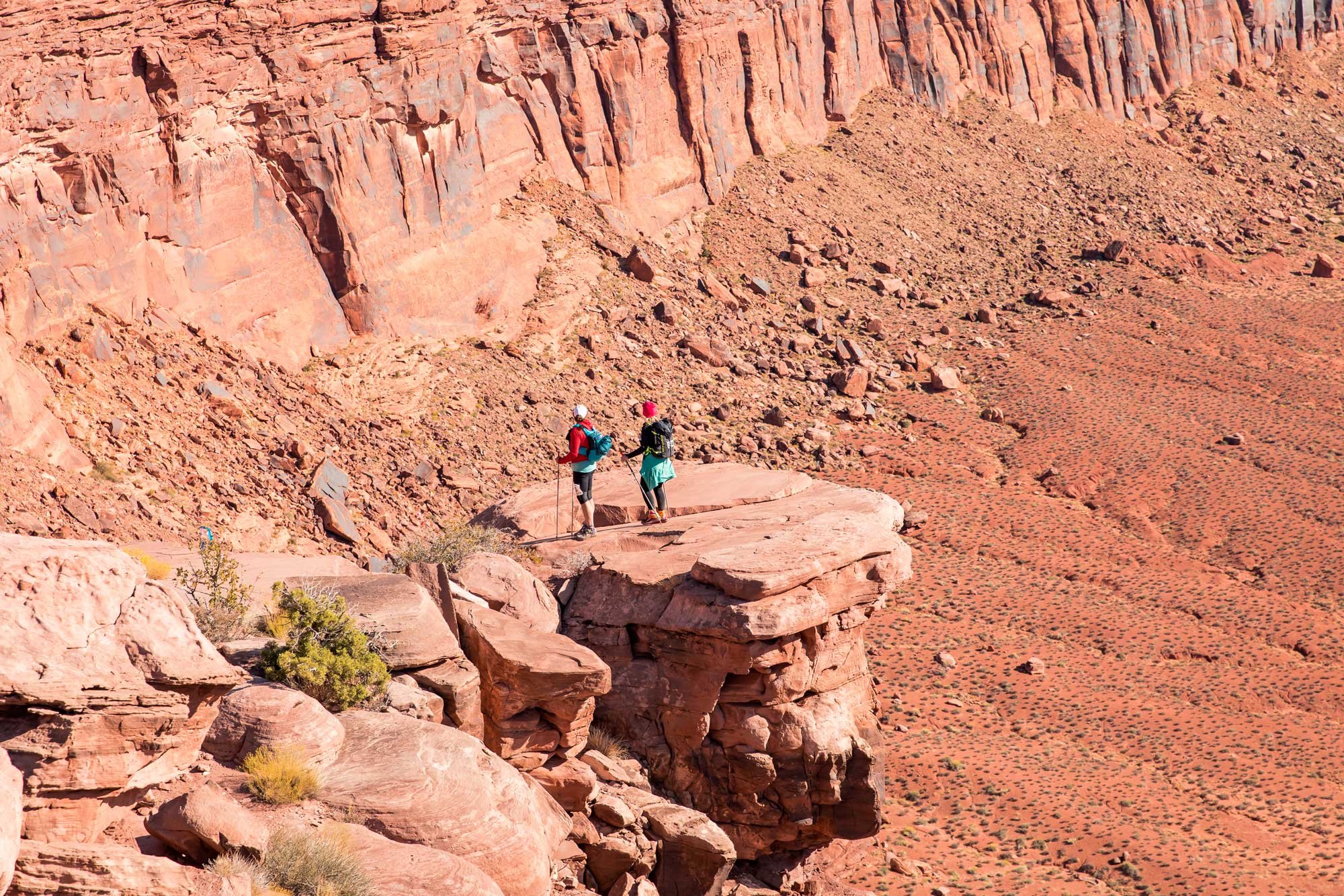  Two female runners looking out over the desert in Moab, Utah 