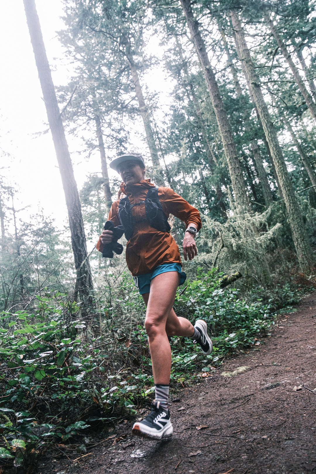  Low perspective as a female runner goes by in the forest 