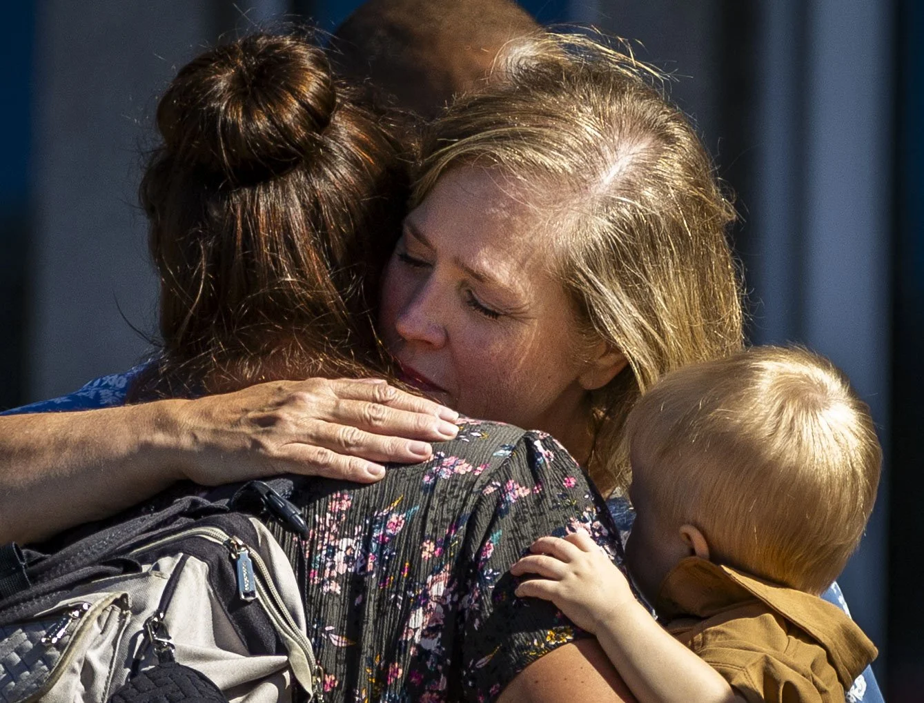 Stephanie Rossello, a member of the Grand Blanc ward, hugs a friend from her ward after their exit from a reunification center after a fire and shooting at a meeting house of The Church of Jesus Christ of Latter-day Saints in Grand Blanc, Michigan, o