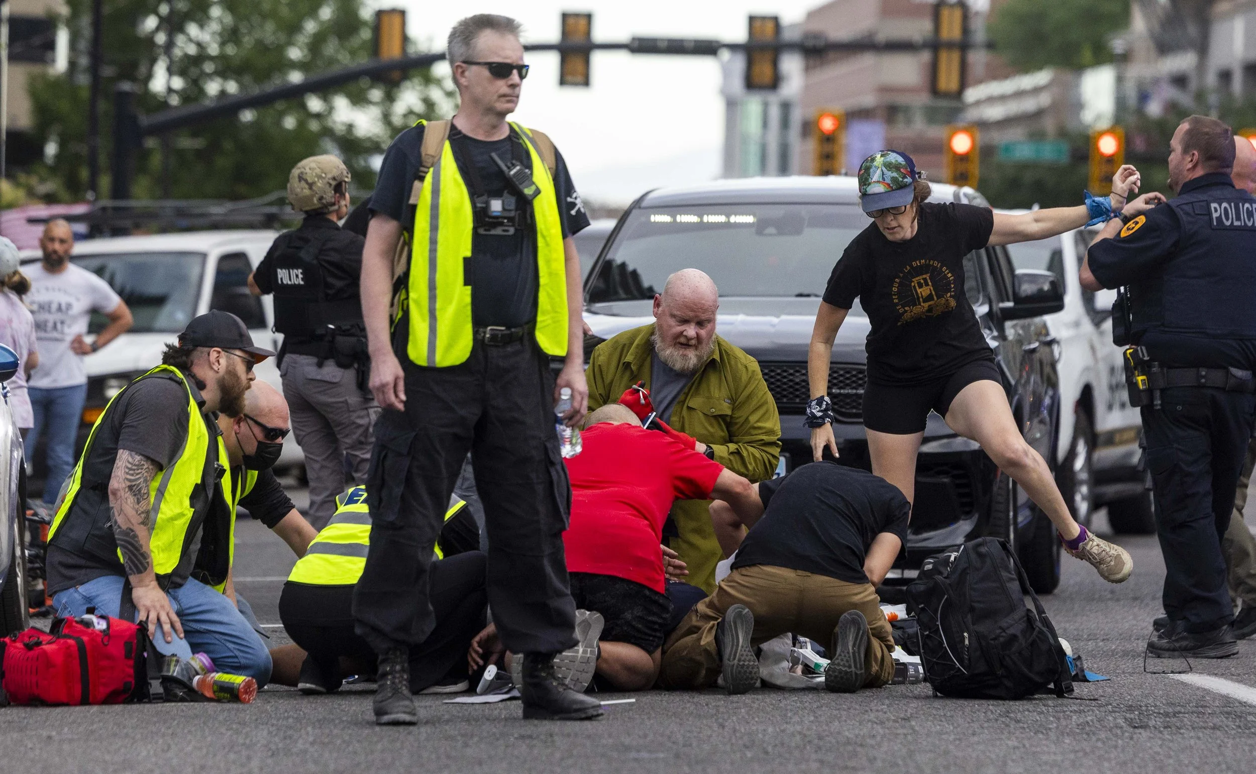 People rush to give medical assistance to a man shot during a “No Kings” protest and march in Salt Lake City on Saturday, June 14, 2025.