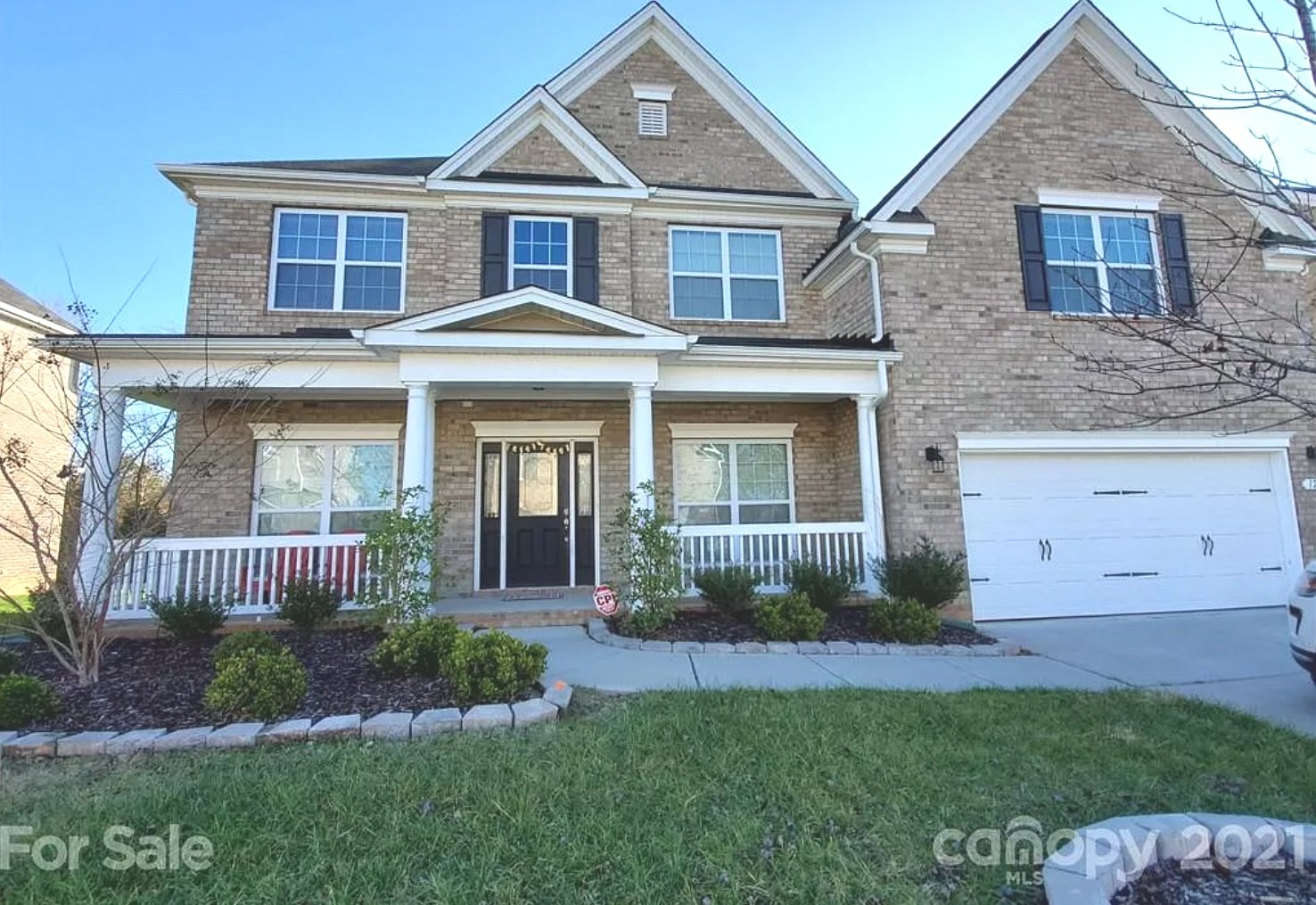 large stone and brick home with front porch located at 1212 autumn ridge, waxhaw, NC