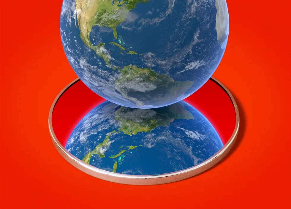 A 3D globe of Earth placed on a round mirror with a red background, showing North and South America, reflected in the mirror.