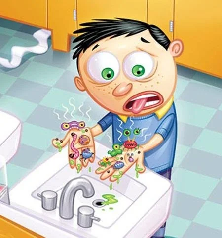 Cartoon boy with big eyes looking surprised at hand full of colorful cartoon germs over a sink.