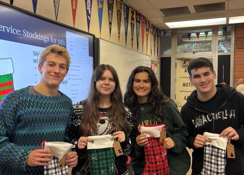 members of the key club pose with stockings