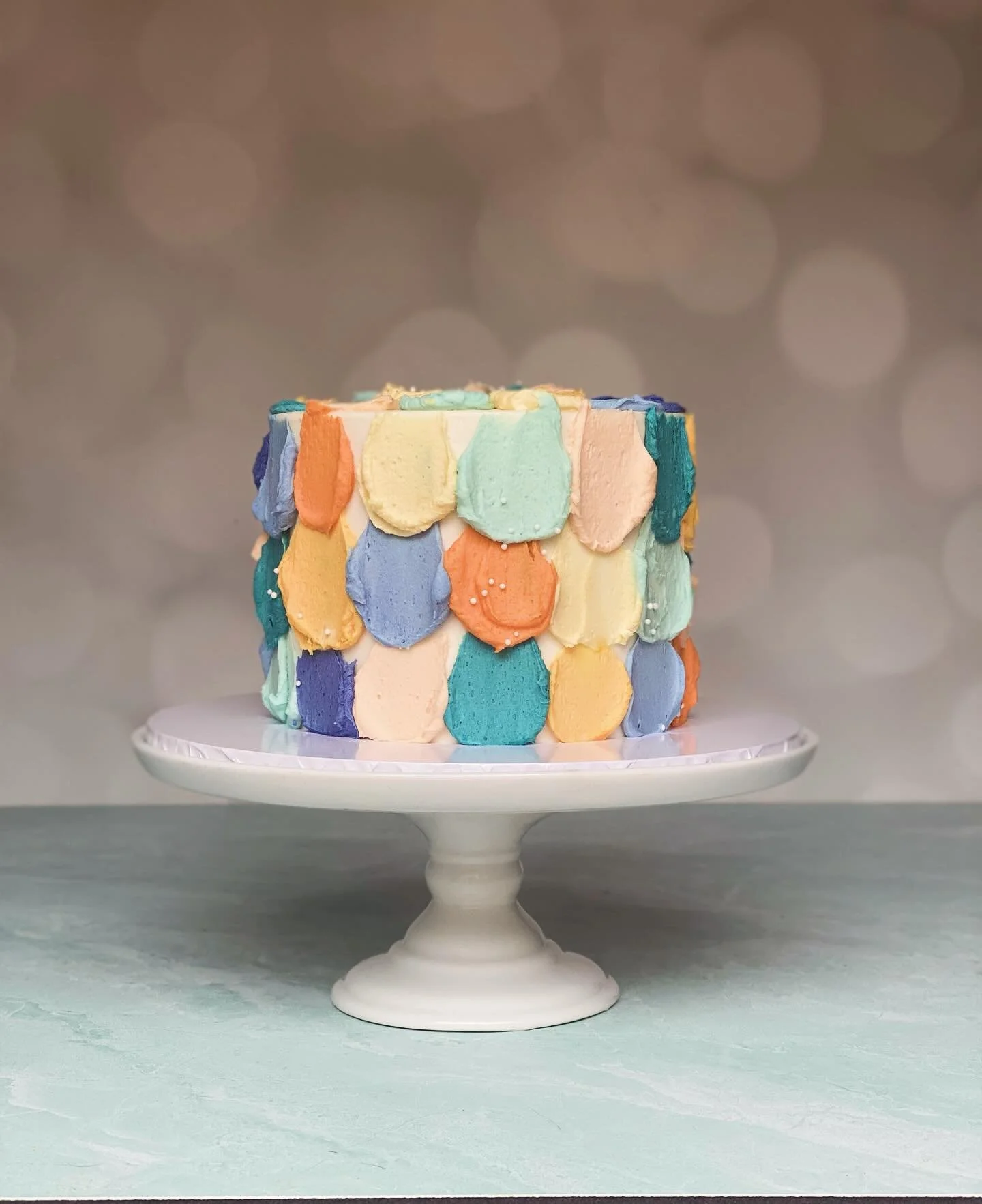 A colorful wee smash cake for baby. 🧡🩵💛

kimslittlecakeshop.com