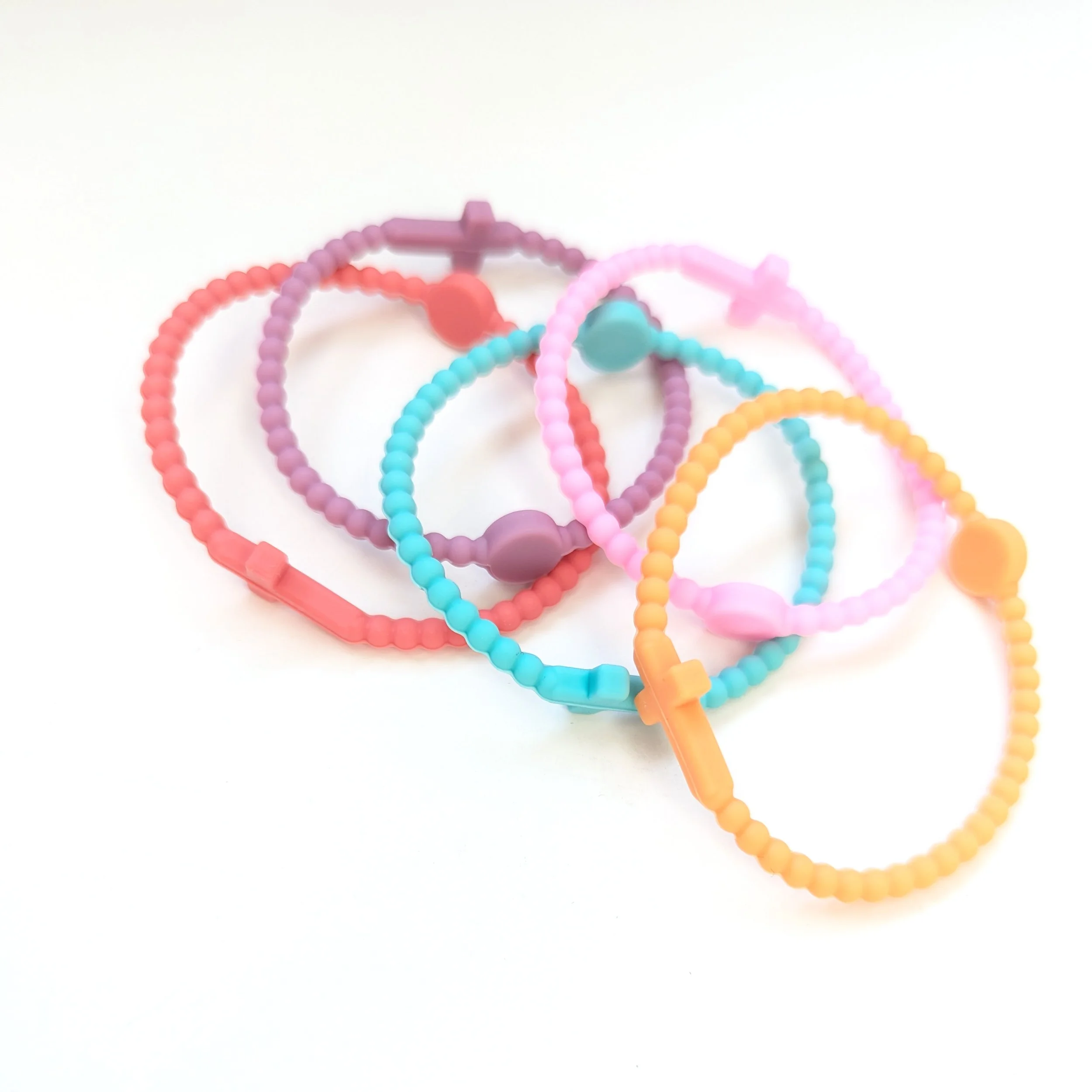 Faith silicone cross bracelets multicolor set of 5 shown in sunset. Set curated by Grace Notes Ltd.