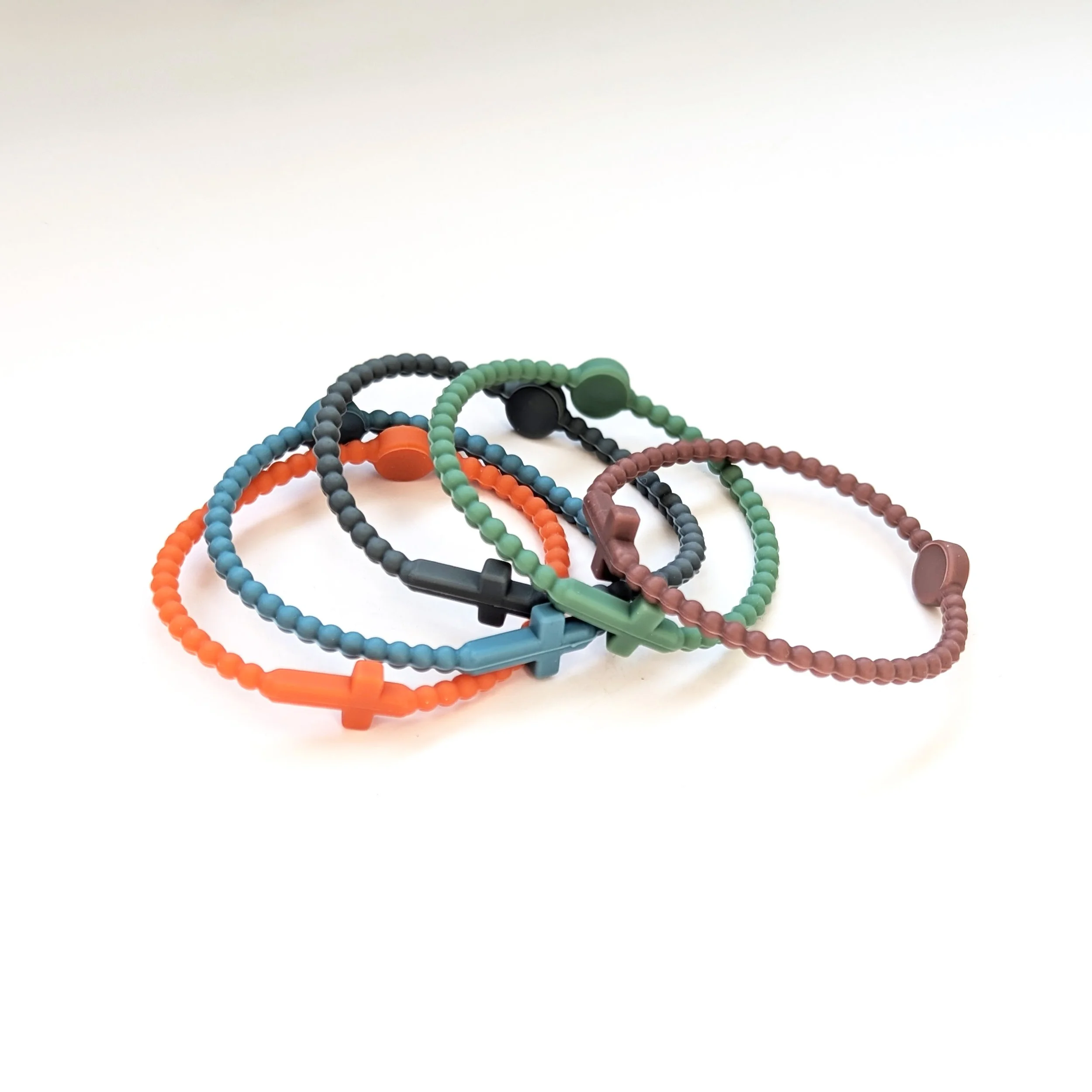 Faith silicone cross bracelets multicolor set of 5 shown in pebble. Set curated by Grace Notes Ltd.